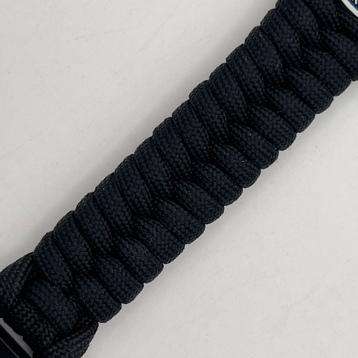 Thick, narrow, and semi-rigid braided United States Navy bracelet featuring an antique silver plated Navy medallion, a black Cobra style tactical buckle and woven with black 550 paracord.