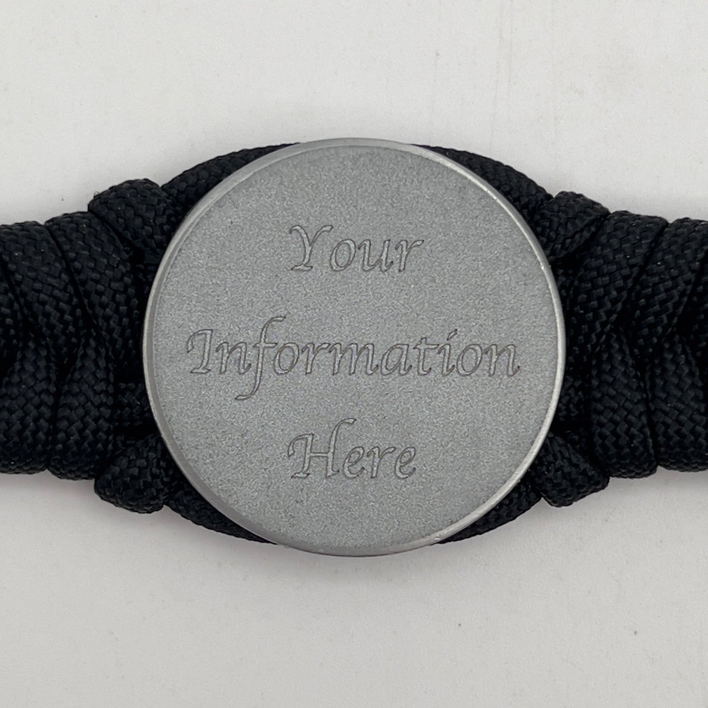 Thick, narrow, and semi-rigid braided United States Navy bracelet featuring an antique silver plated Navy medallion, a black Cobra style tactical buckle and woven with black 550 paracord.