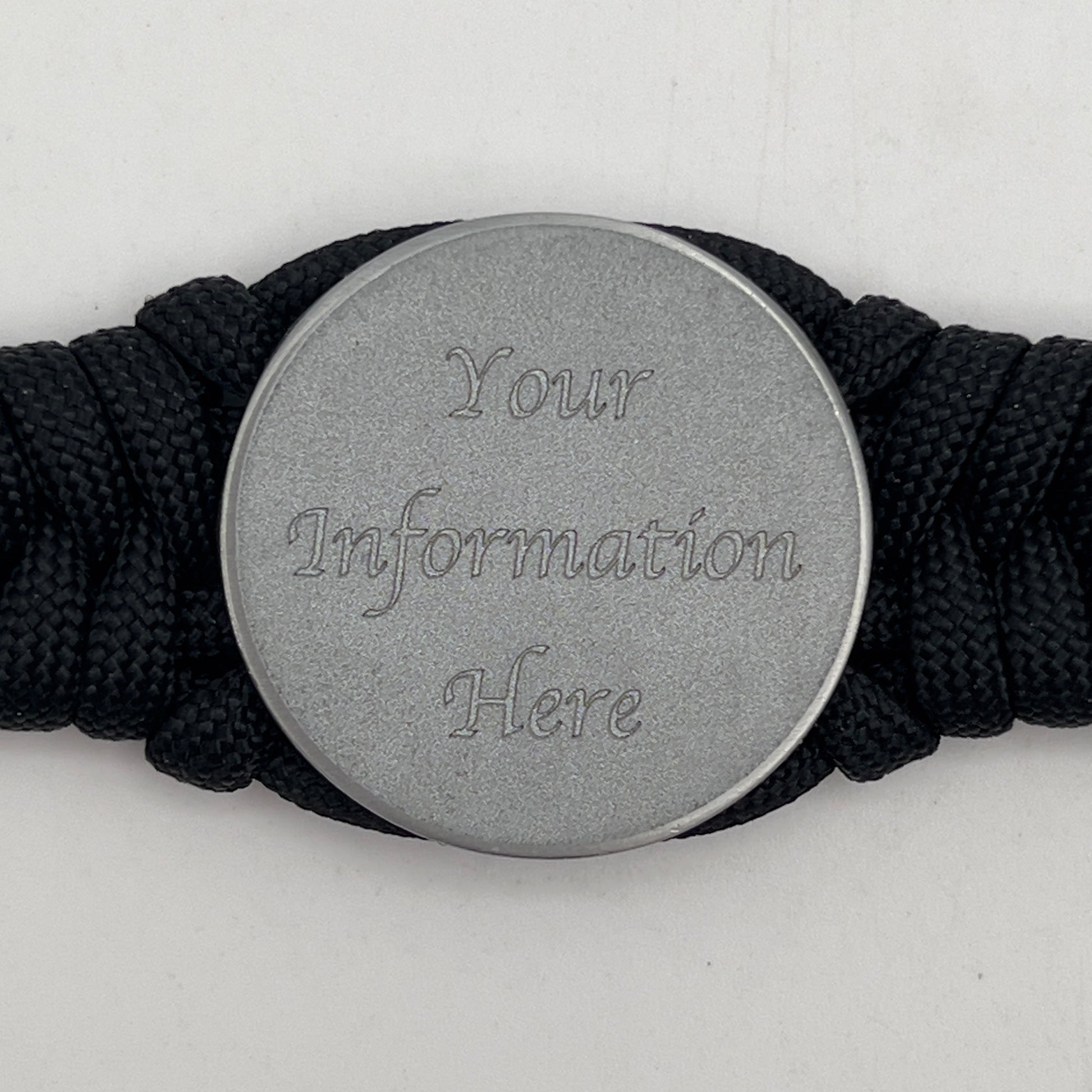 Thick, narrow, and semi-rigid braided United States Navy bracelet featuring an antique silver plated Navy medallion, a black Cobra style tactical buckle and woven with black 550 paracord.