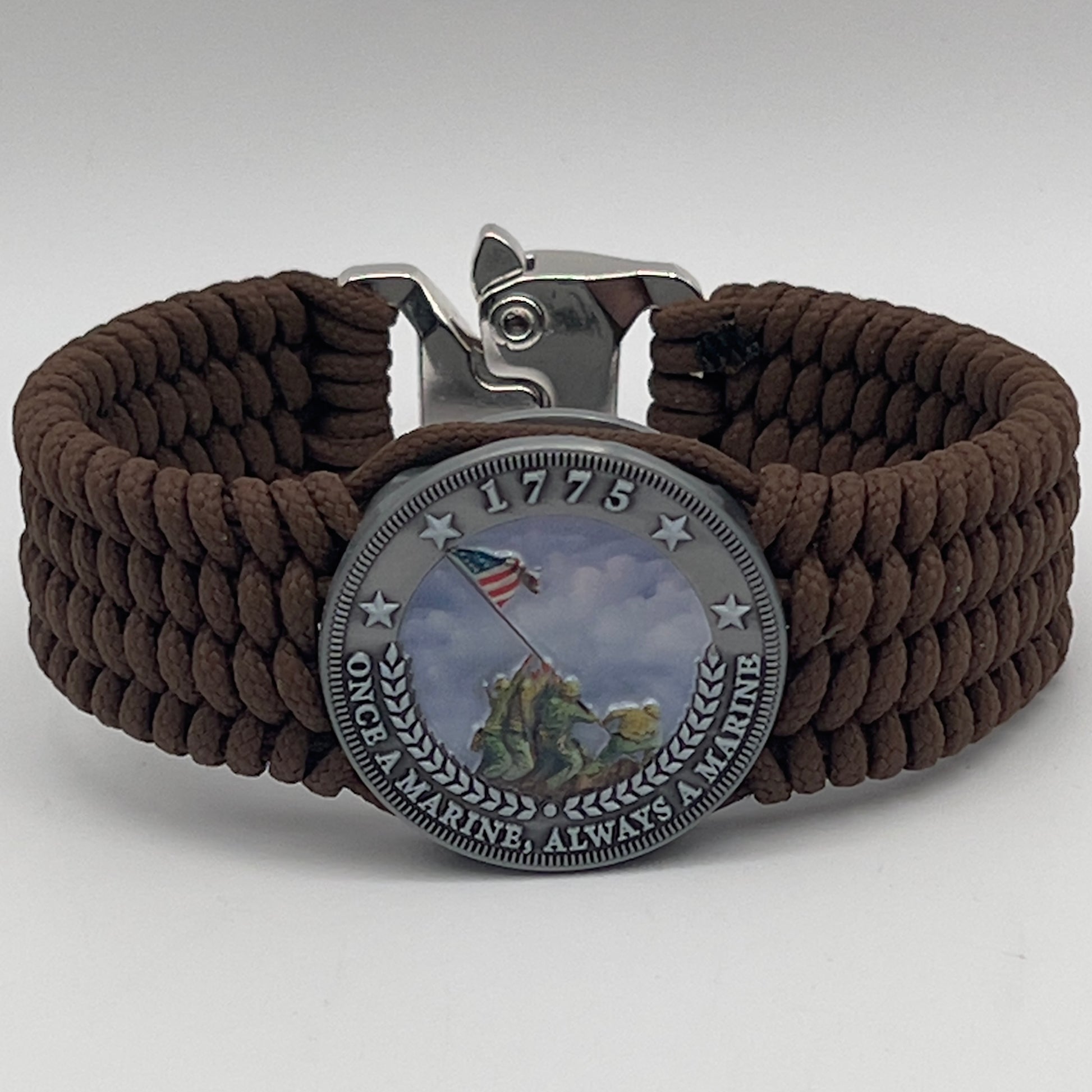 Thin, wide, flexible and comfortable braided United States Marine Corps Iwo Jima bracelet featuring an antique silver plated UV painted Iwo Jima flag raising medallion, a silver Cobra style tactical buckle and woven with Coyote Brown Type-1 paracord.