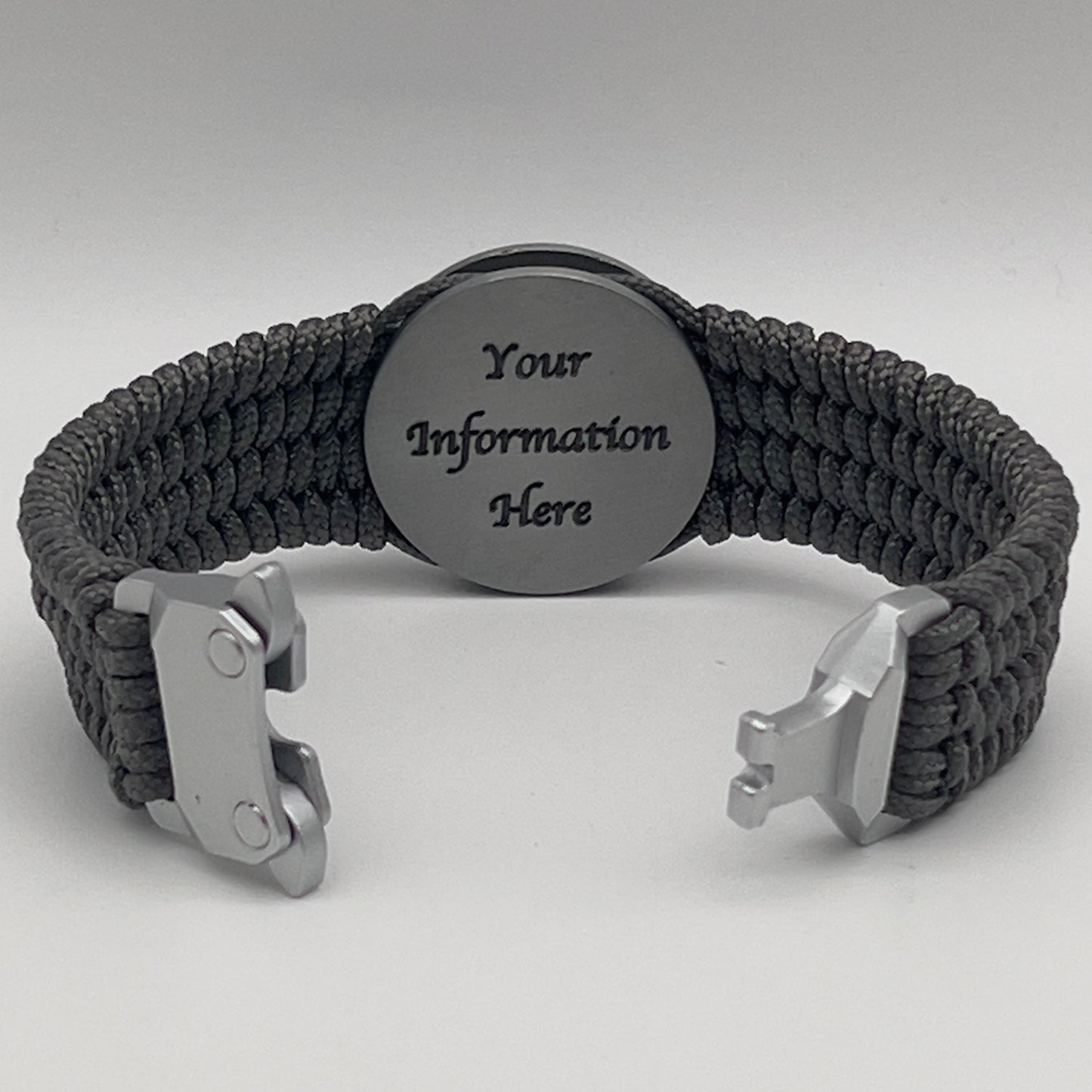 Thin, wide, flexible and comfortable braided United States Marine Corps Iwo Jima bracelet featuring an antique silver plated Iwo Jima flag raising medallion, a silver Cobra style tactical buckle and woven with gray Type-1 paracord.