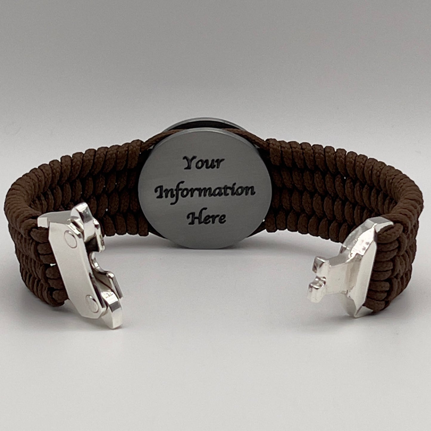 Thin, wide, flexible and comfortable braided United States Marine Corps Iwo Jima bracelet featuring an antique silver plated Iwo Jima flag raising medallion, a silver Cobra style tactical buckle and woven with Coyote Brown Type-1 paracord.