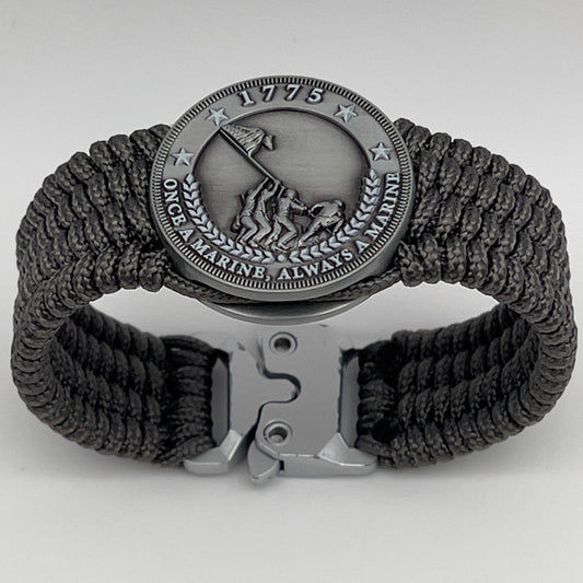 Thin, wide, flexible and comfortable braided United States Marine Corps Iwo Jima bracelet featuring an antique silver plated Iwo Jima flag raising medallion, a silver Cobra style tactical buckle and woven with gray Type-1 paracord.