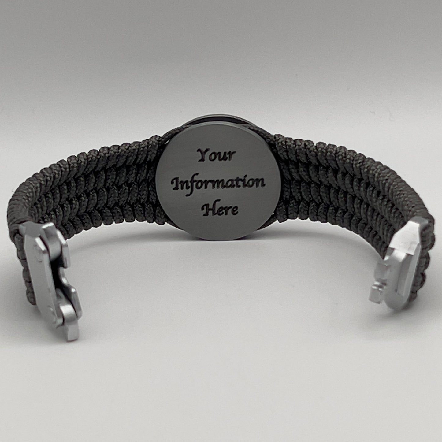 Thin, wide, flexible and comfortable braided United States Marine Corps Iwo Jima bracelet featuring an antique silver plated Iwo Jima flag raising medallion, a silver Cobra style tactical buckle and woven with gray Type-1 paracord.