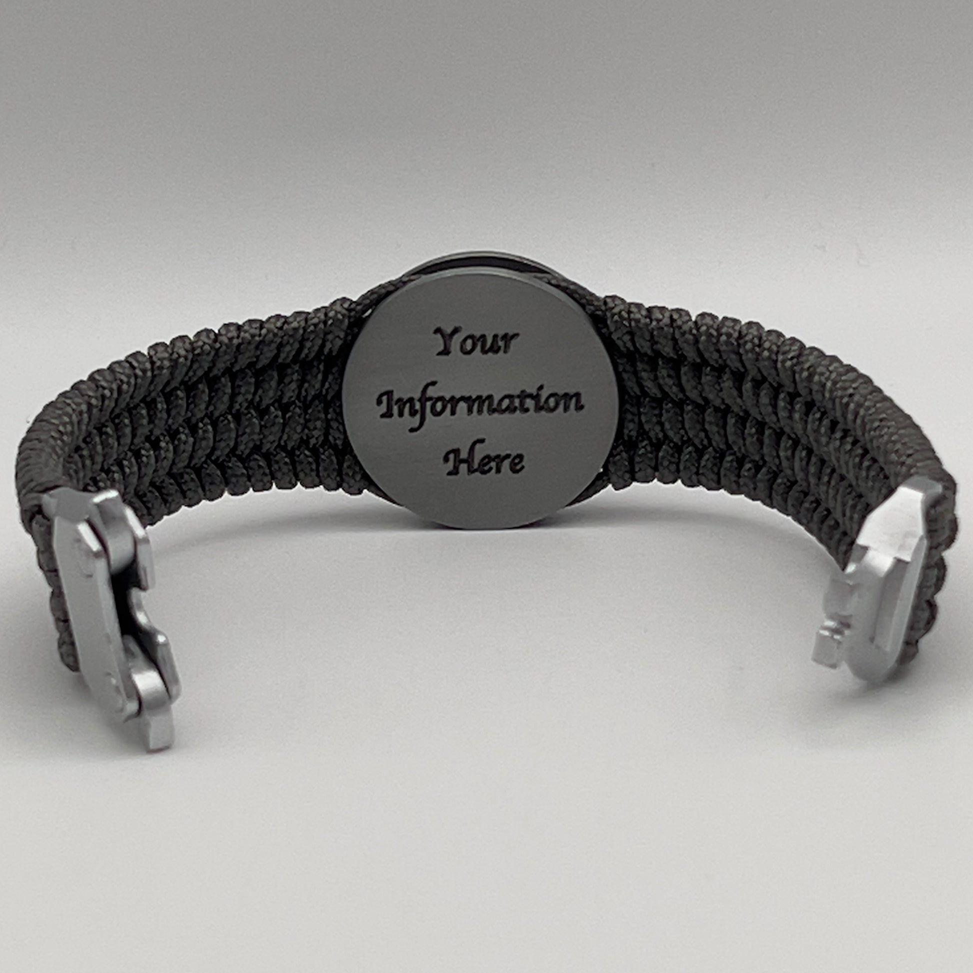 Thin, wide, flexible and comfortable braided United States Marine Corps Iwo Jima bracelet featuring an antique silver plated Iwo Jima flag raising medallion, a silver Cobra style tactical buckle and woven with gray Type-1 paracord.