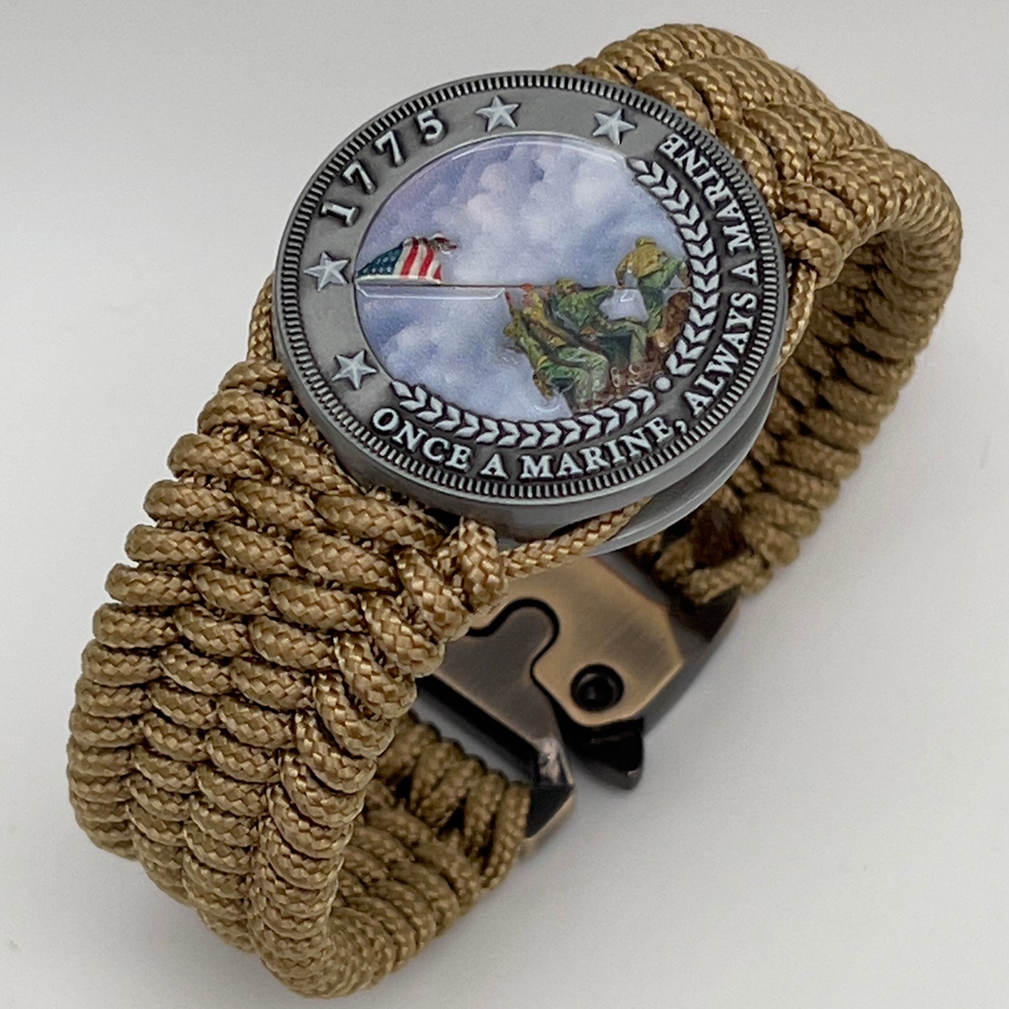 Thin, wide, flexible and comfortable braided United States Marine Corps Iwo Jima bracelet featuring an antique silver plated Iwo Jima flag raising medallion, a gold Cobra style tactical buckle and woven with gold Type-1 paracord.