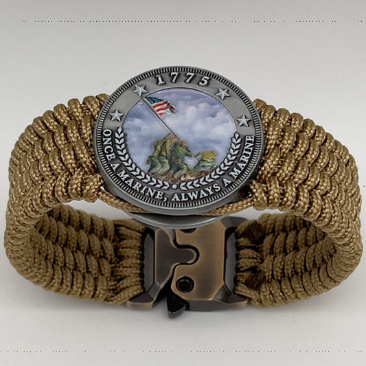 Thin, wide, flexible and comfortable braided United States Marine Corps Iwo Jima bracelet featuring an antique silver plated Iwo Jima flag raising medallion, a gold Cobra style tactical buckle and woven with gold Type-1 paracord.
