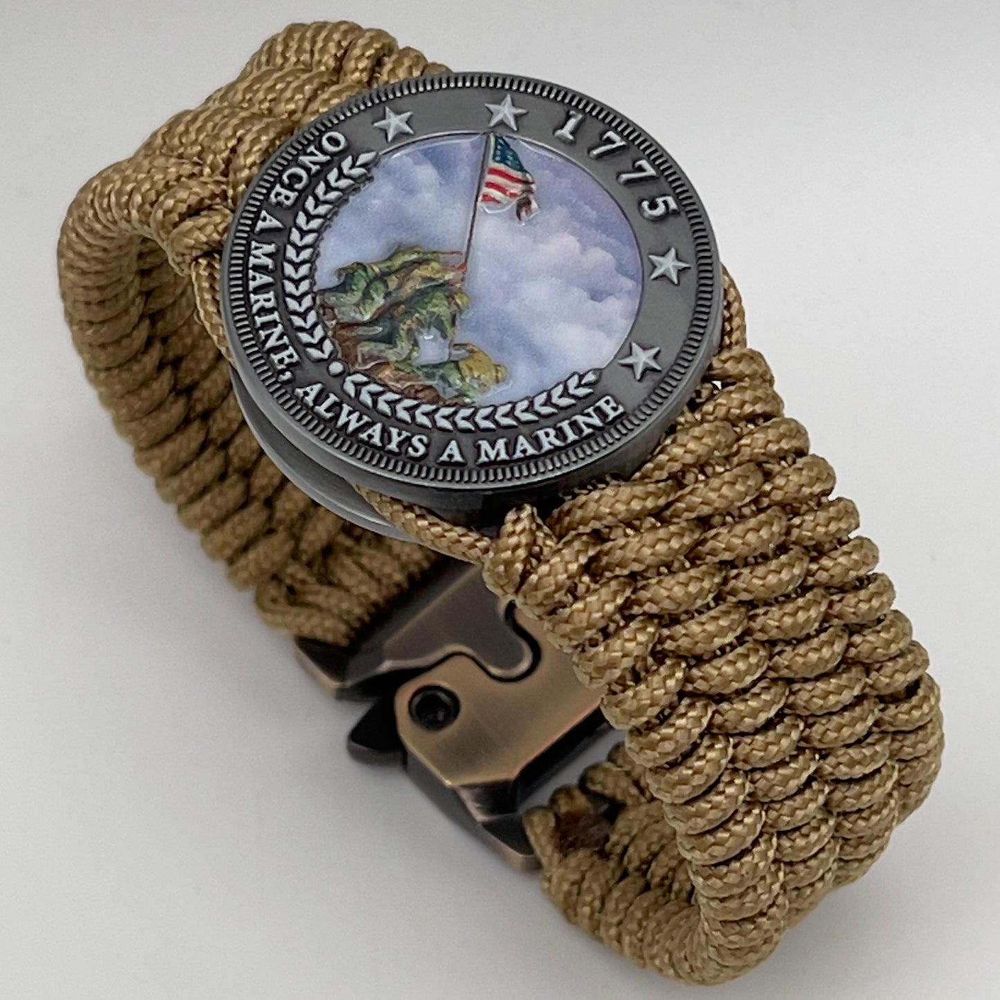 Thin, wide, flexible and comfortable braided United States Marine Corps Iwo Jima bracelet featuring an antique silver plated Iwo Jima flag raising medallion, a gold Cobra style tactical buckle and woven with gold Type-1 paracord.