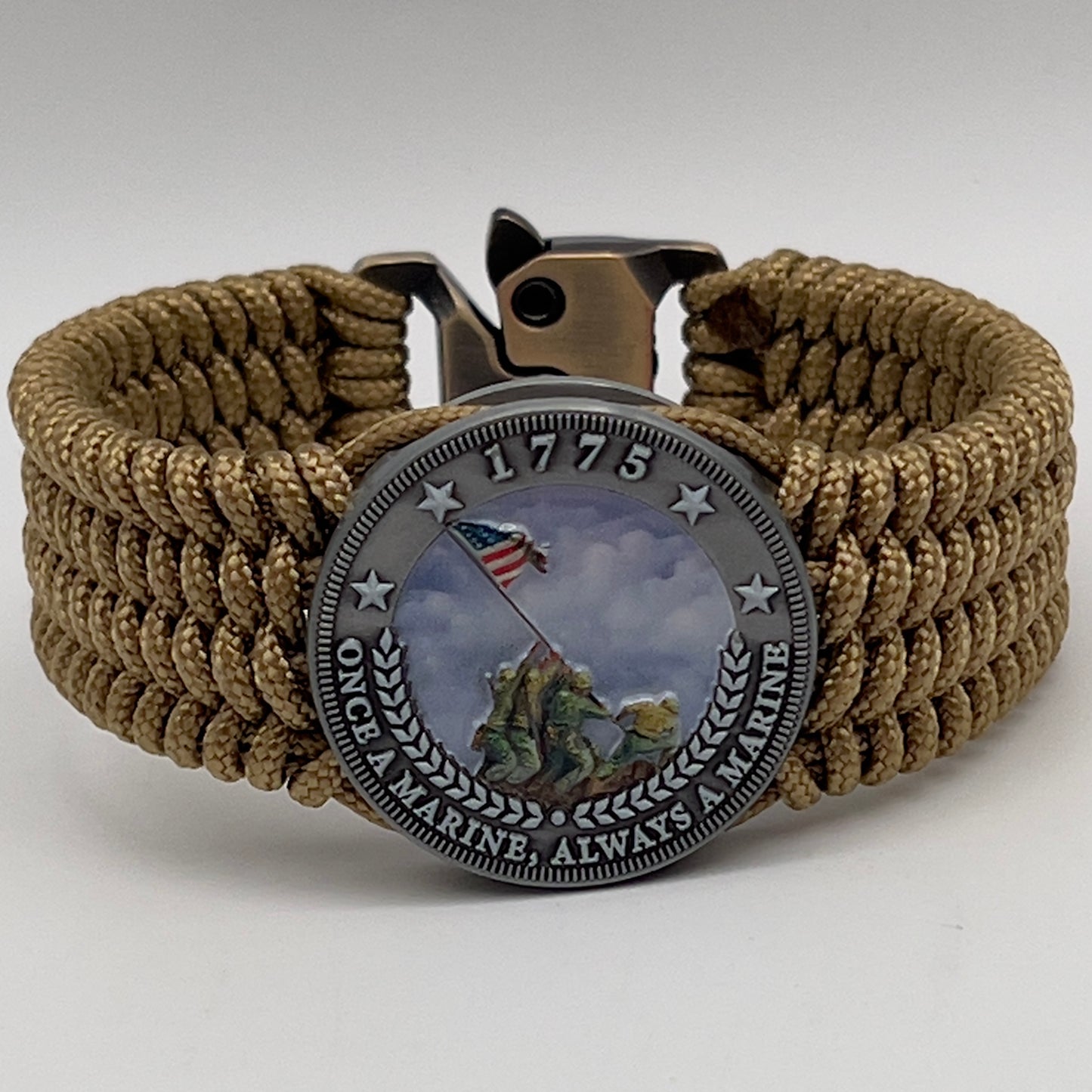 Thin, wide, flexible and comfortable braided United States Marine Corps Iwo Jima bracelet featuring an antique silver plated Iwo Jima flag raising medallion, a gold Cobra style tactical buckle and woven with gold Type-1 paracord.