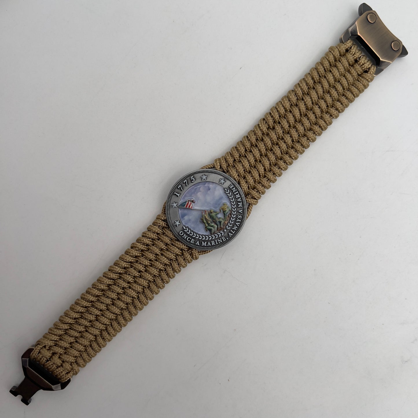 Thin, wide, flexible and comfortable braided United States Marine Corps Iwo Jima bracelet featuring an antique silver plated Iwo Jima flag raising medallion, a gold Cobra style tactical buckle and woven with gold Type-1 paracord.