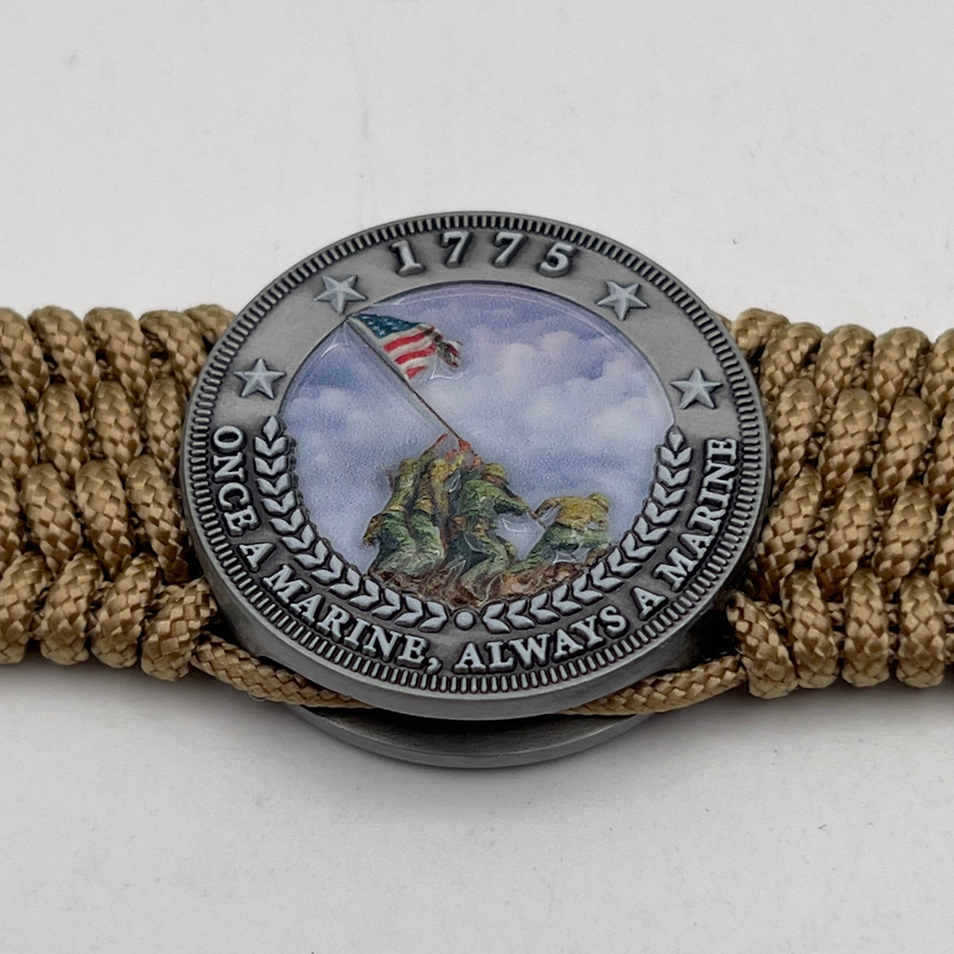 Thin, wide, flexible and comfortable braided United States Marine Corps Iwo Jima bracelet featuring an antique silver plated Iwo Jima flag raising medallion, a gold Cobra style tactical buckle and woven with gold Type-1 paracord.
