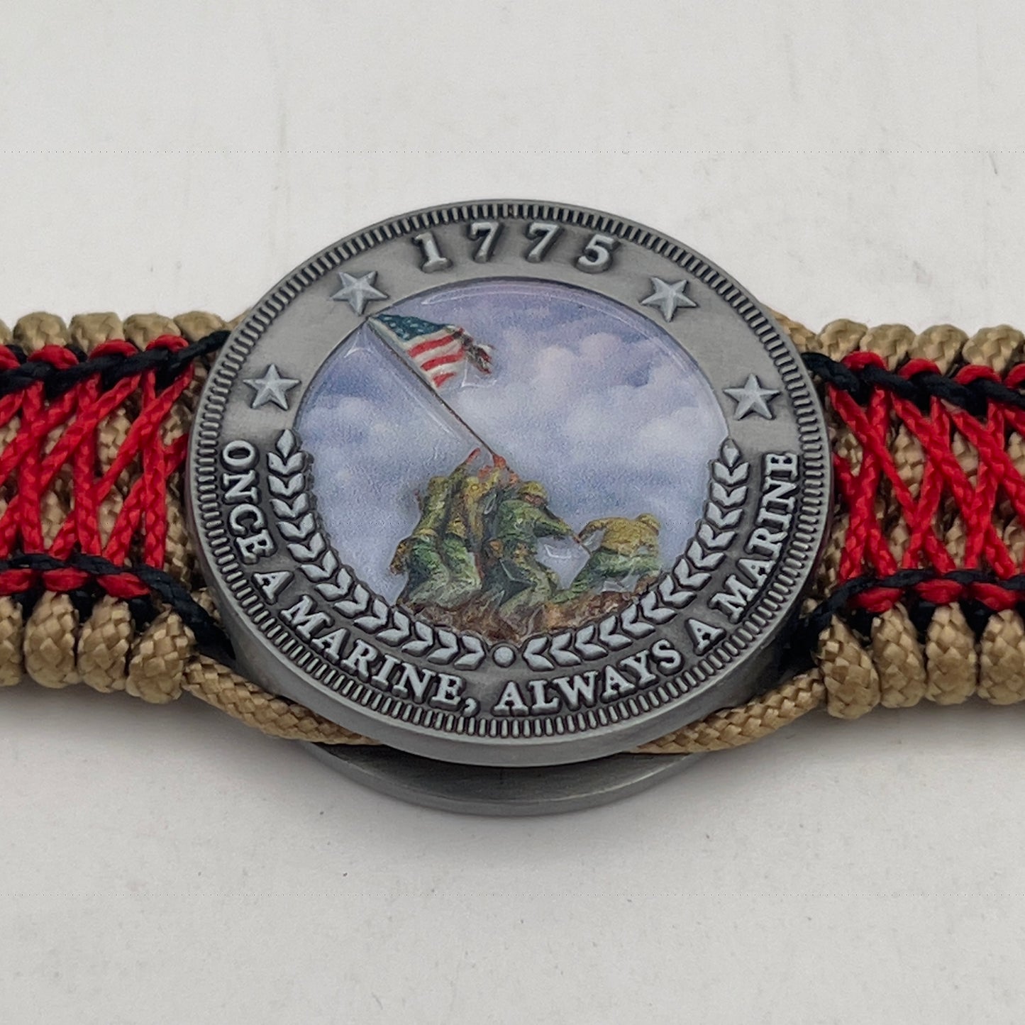 Thin, medium width, flexible and comfortable braided United States Marine Corps Iwo Jima bracelet featuring a UV painted antique silver plated Iwo Jima flag raising medallion, a gold Cobra style tactical buckle and woven with gold Type-1 paracord and Imperial Red and black nano cord.