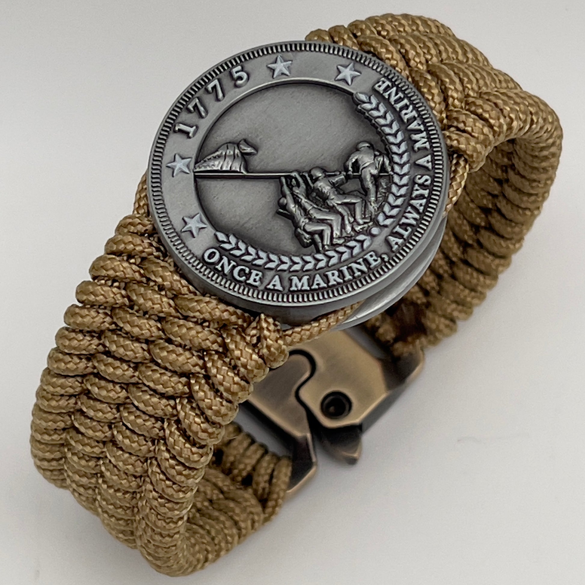 Thin, wide, flexible and comfortable braided United States Marine Corps Iwo Jima bracelet featuring an antique silver plated Iwo Jima flag raising medallion, a gold Cobra style tactical buckle and woven with gold Type-1 paracord.