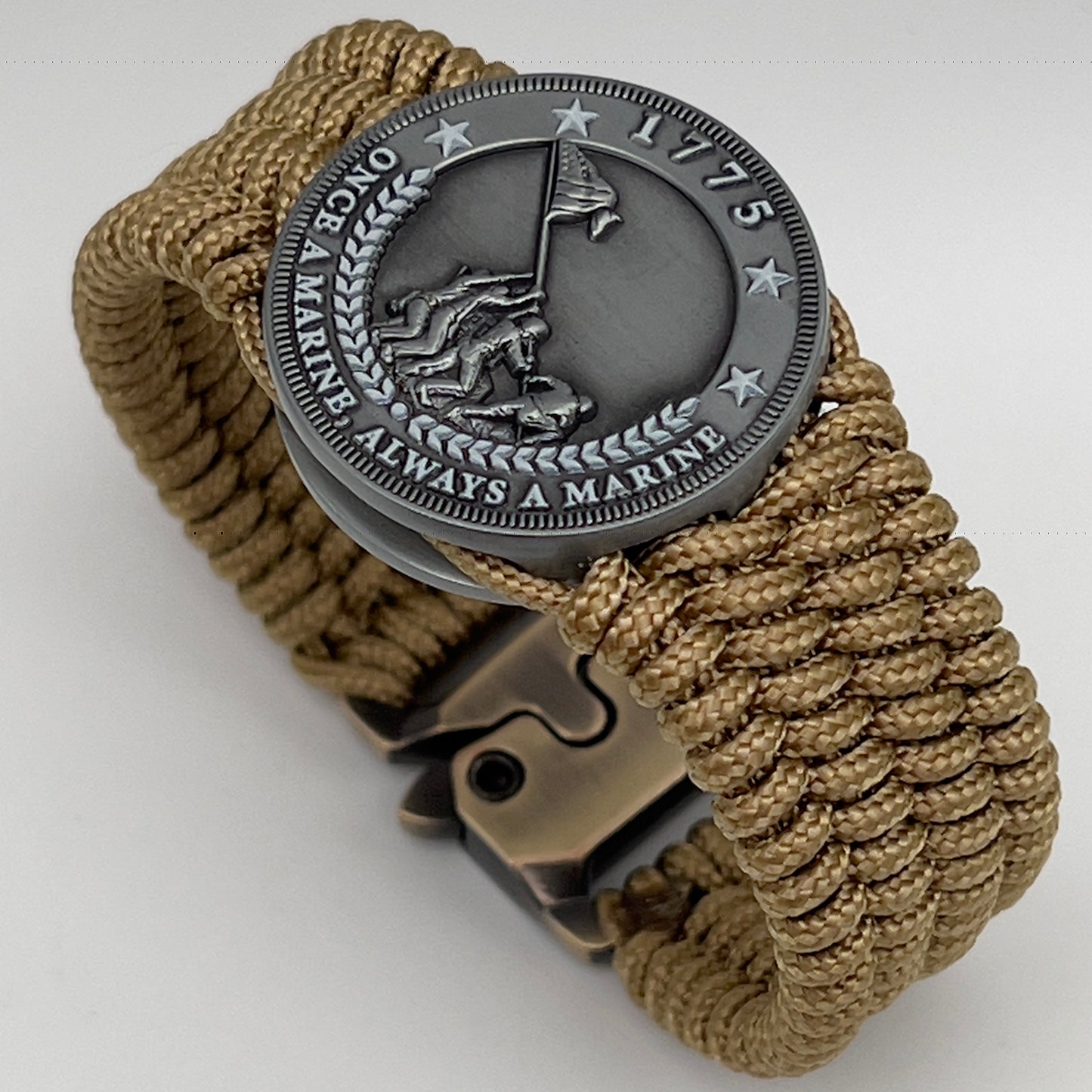 Thin, wide, flexible and comfortable braided United States Marine Corps Iwo Jima bracelet featuring an antique silver plated Iwo Jima flag raising medallion, a gold Cobra style tactical buckle and woven with gold Type-1 paracord.