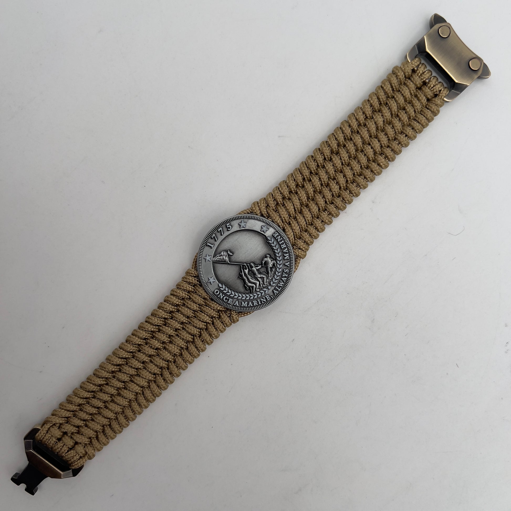 Thin, wide, flexible and comfortable braided United States Marine Corps Iwo Jima bracelet featuring an antique silver plated Iwo Jima flag raising medallion, a gold Cobra style tactical buckle and woven with gold Type-1 paracord.