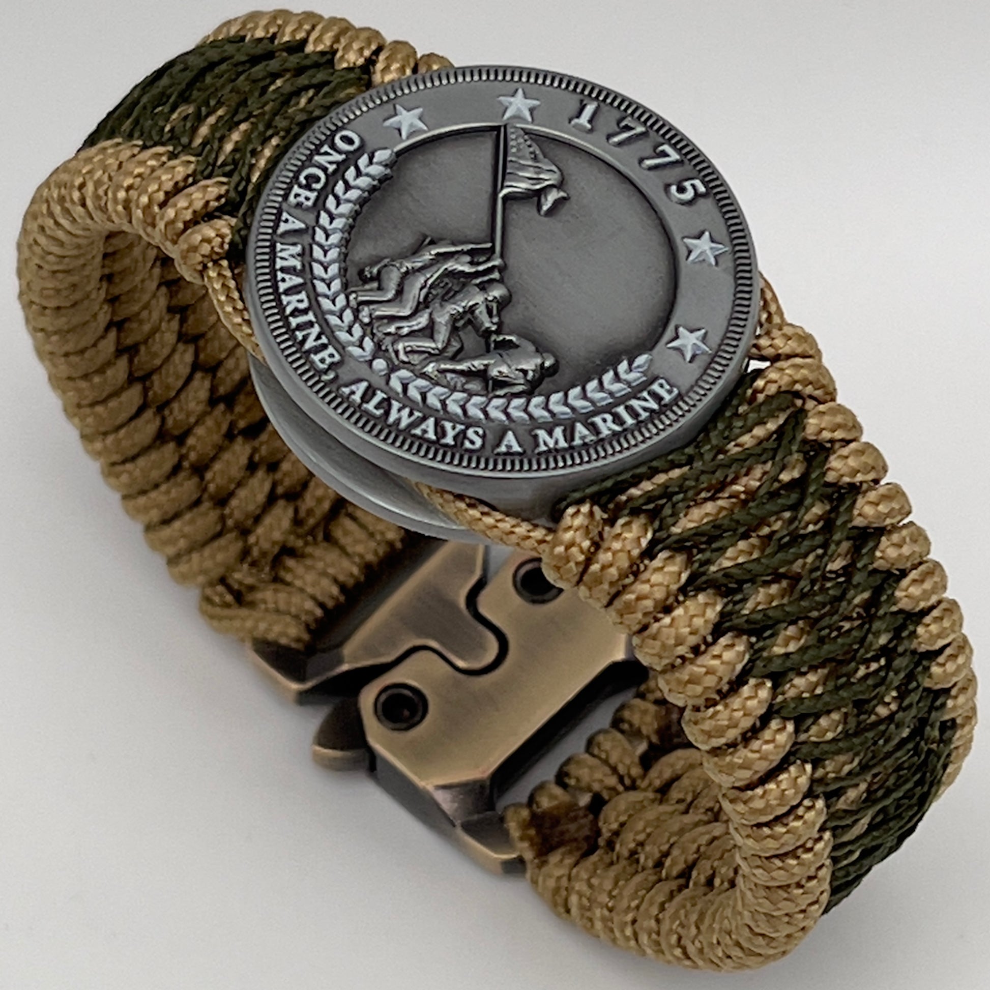 Thin, wide, flexible and comfortable braided United States Marine Corps Iwo Jima bracelet featuring an antique silver plated Iwo Jima flag raising medallion, a gold Cobra style tactical buckle and woven with gold Type-1 paracord and Olive Drab nano cord.