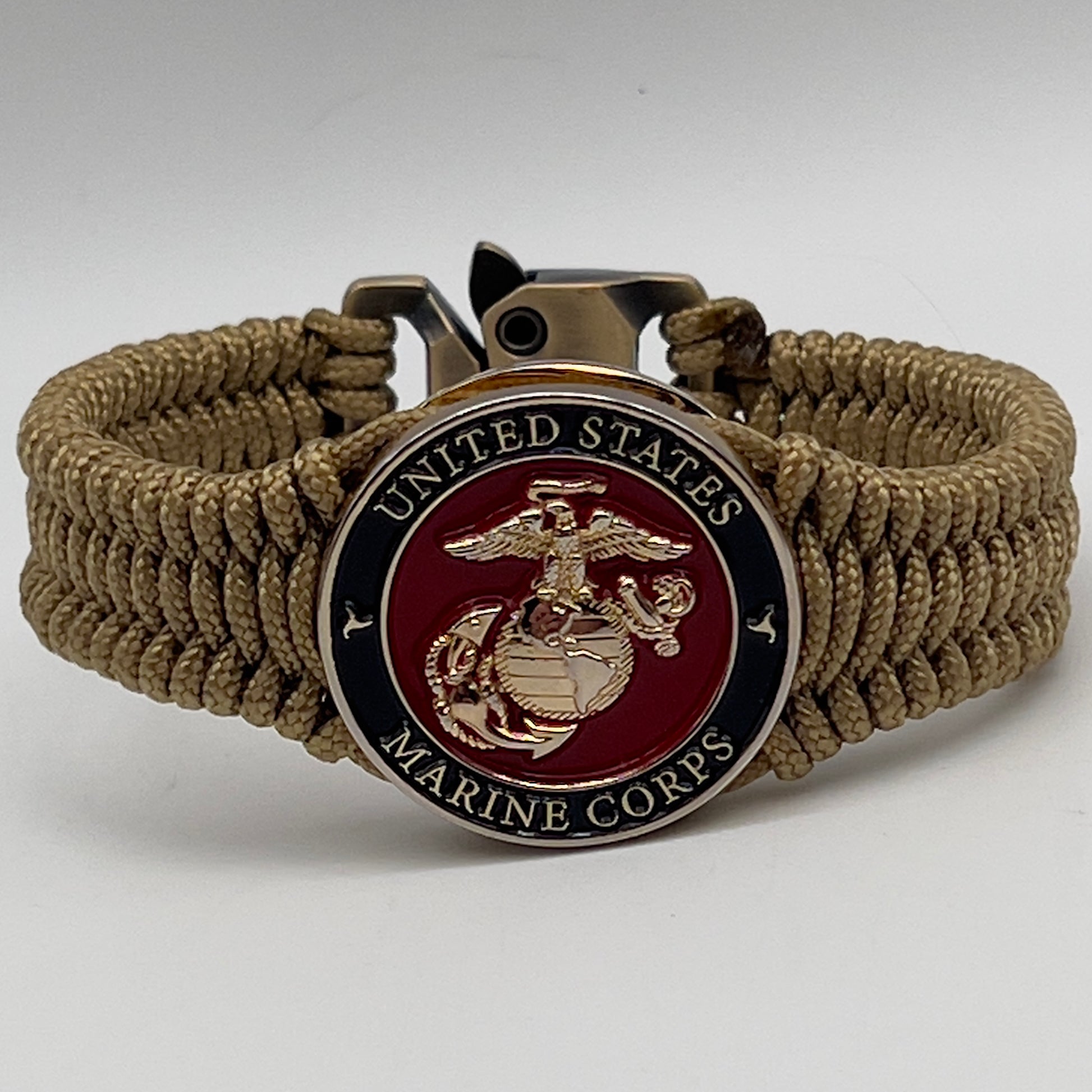 Thick, narrow, flexible and comfortable braided United States Marine Corps bracelet featuring a 24K gold plated USMC officer Eagle Globe and Anchor medallion, a gold Cobra style tactical buckle and woven with gold Type-1 paracord.