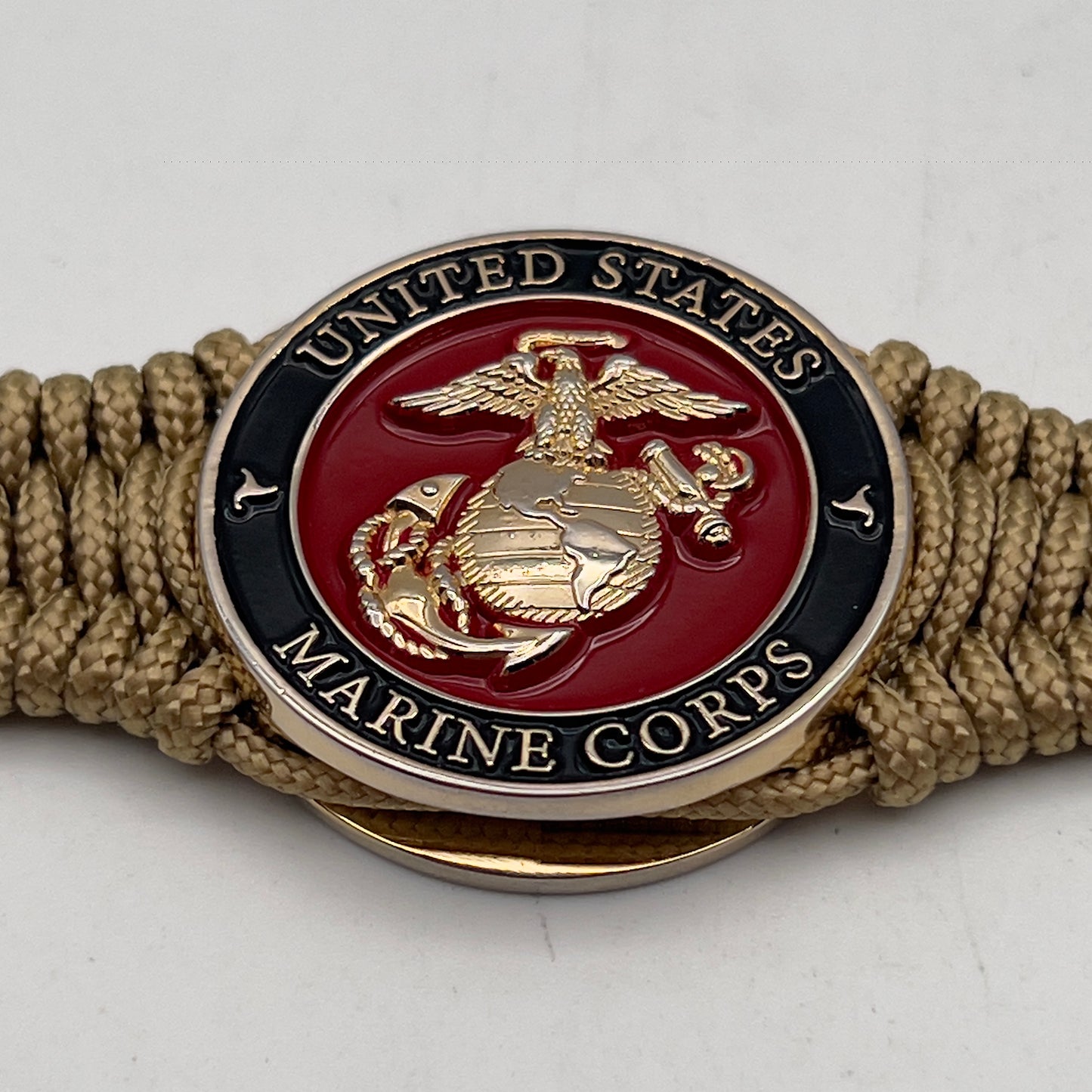 Thick, narrow, flexible and comfortable braided United States Marine Corps bracelet featuring a 24K gold plated USMC officer Eagle Globe and Anchor medallion, a gold Cobra style tactical buckle and woven with gold Type-1 paracord.