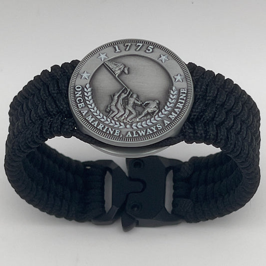 Thin, wide, flexible and comfortable braided United States Marine Corps Iwo Jima bracelet featuring an antique silver plated Iwo Jima flag raising medallion, a black Cobra style tactical buckle and woven with black Type-1 paracord.
