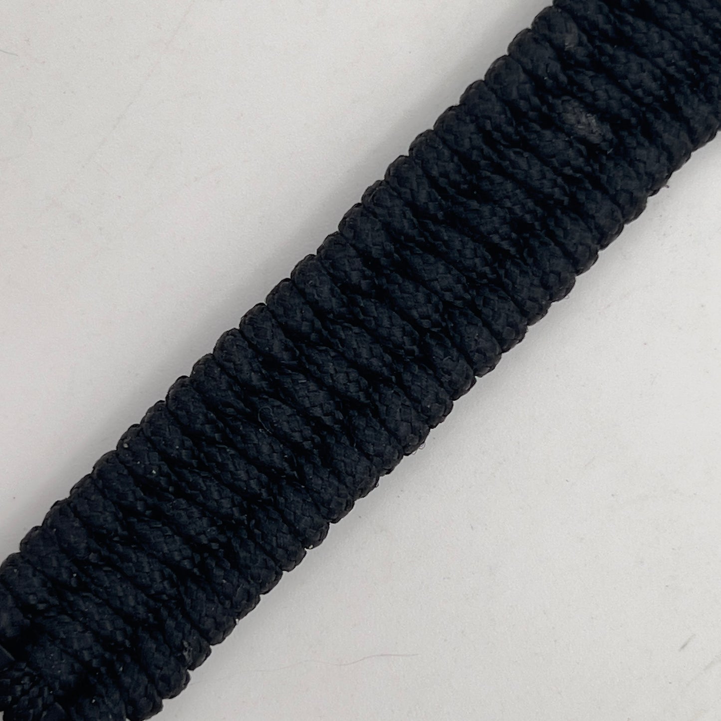 Thin, narrow and comfortable braided United States Marine Corps Iwo Jima bracelet featuring an antique silver plated UV painted Iwo Jima flag raising medallion, a black Cobra style tactical buckle and woven with black type-1 paracord.