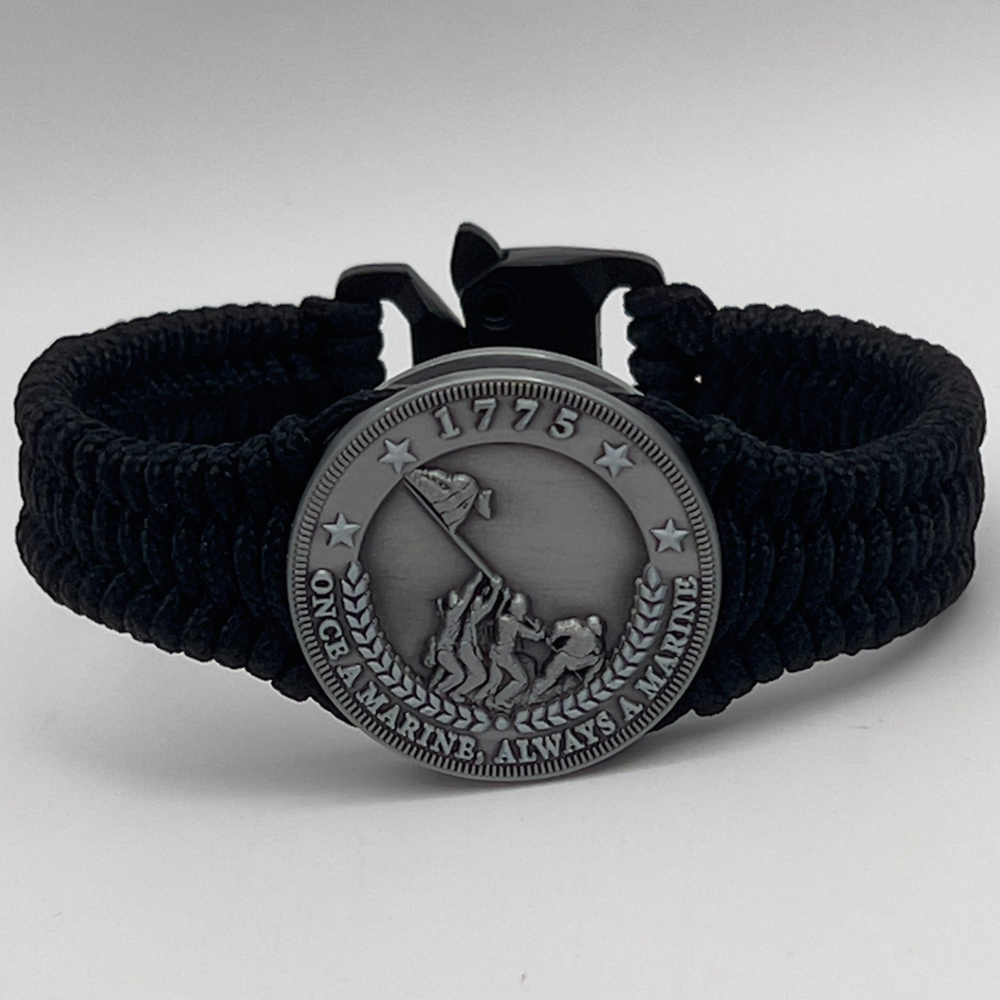 Thin, narrow and comfortable braided United States Marine Corps Iwo Jima bracelet featuring an antique silver plated Iwo Jima flag raising medallion, a black Cobra style tactical buckle and woven with black type-1 paracord.
