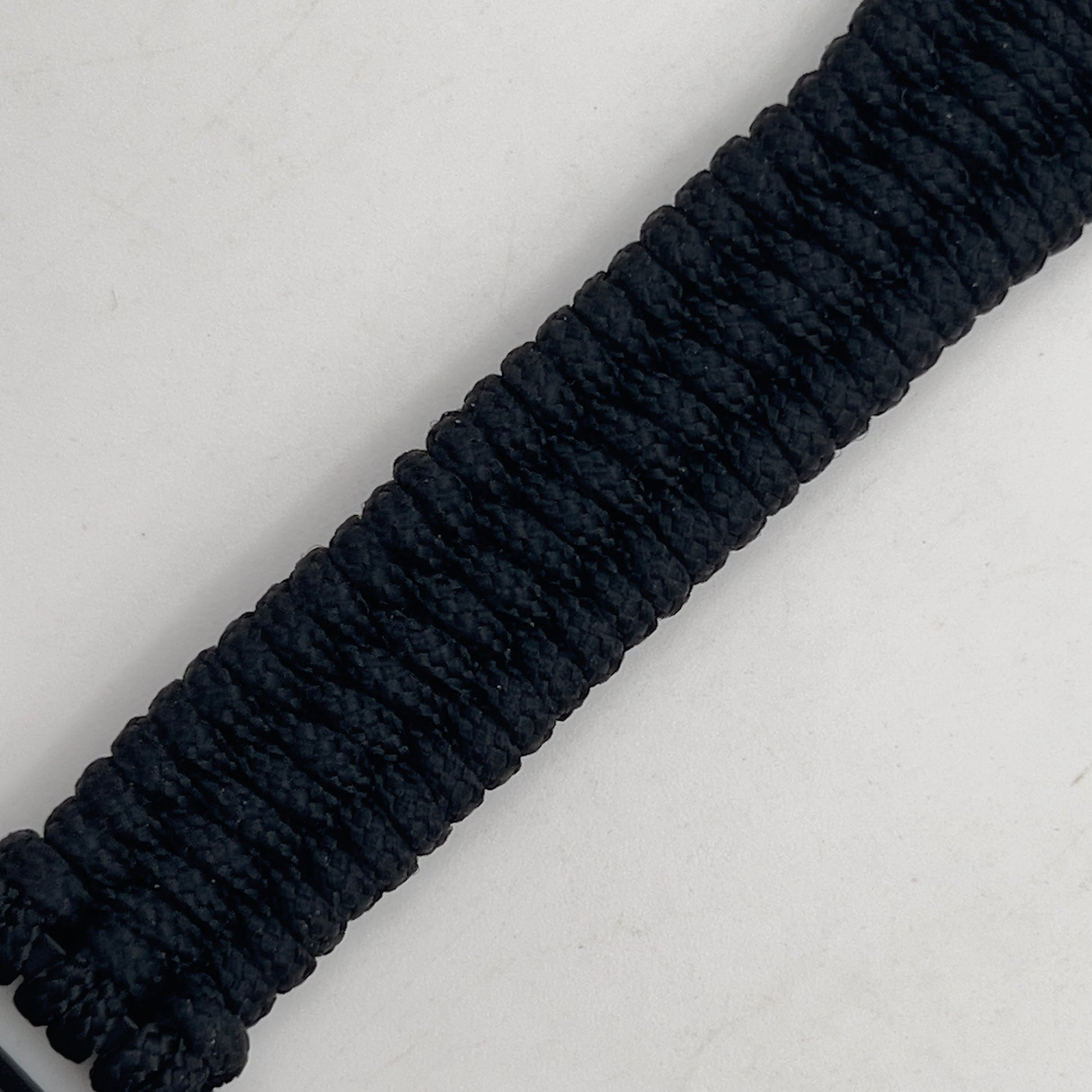 Thin, narrow and comfortable braided United States Marine Corps Iwo Jima bracelet featuring an antique silver plated Iwo Jima flag raising medallion, a black Cobra style tactical buckle and woven with black type-1 paracord.