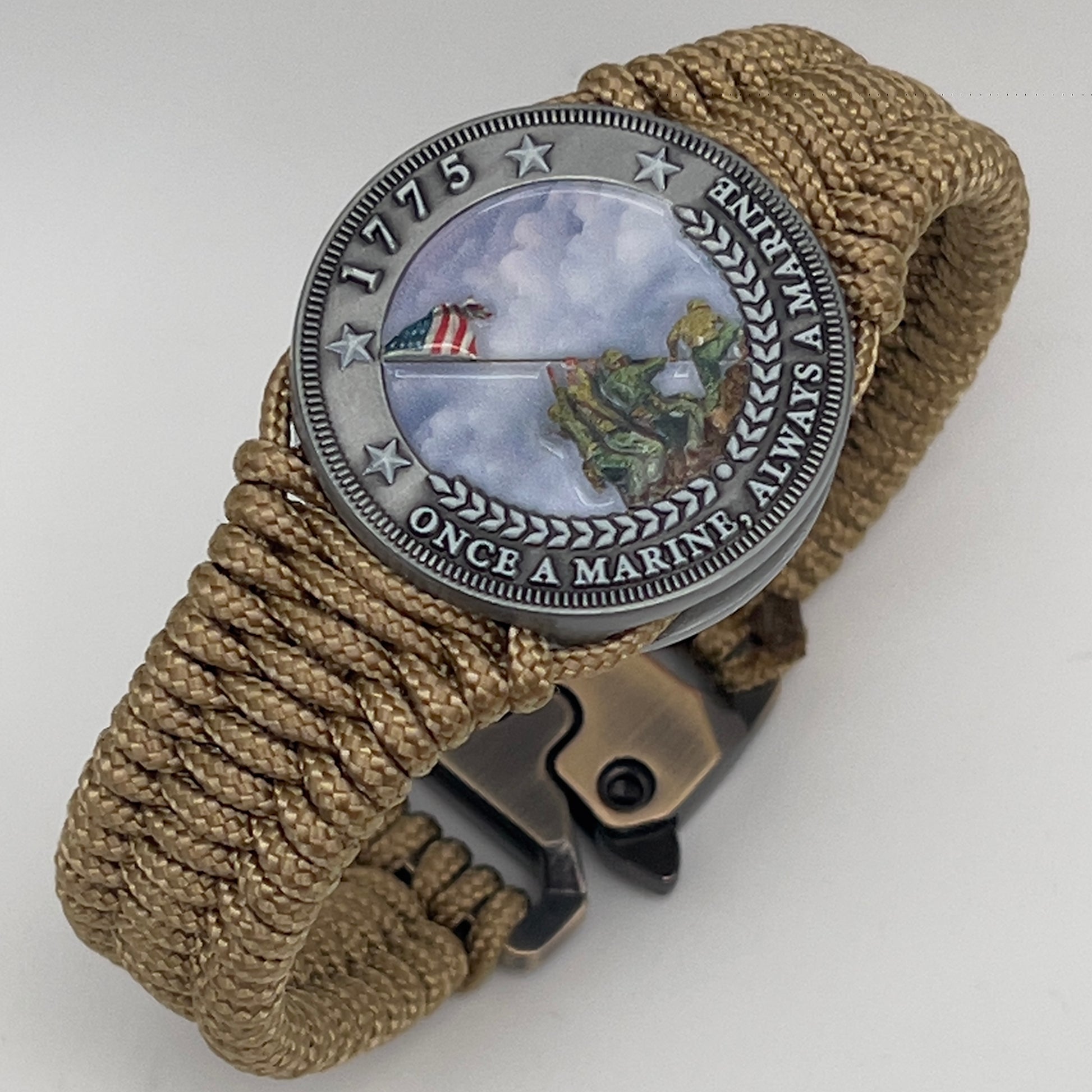 Thin, narrow, flexible and comfortable braided United States Marine Corps Iwo Jima bracelet featuring an antique silver plated UV painted Iwo Jima flag raising medallion, a gold Cobra style tactical buckle and woven with gold type-1 paracord.