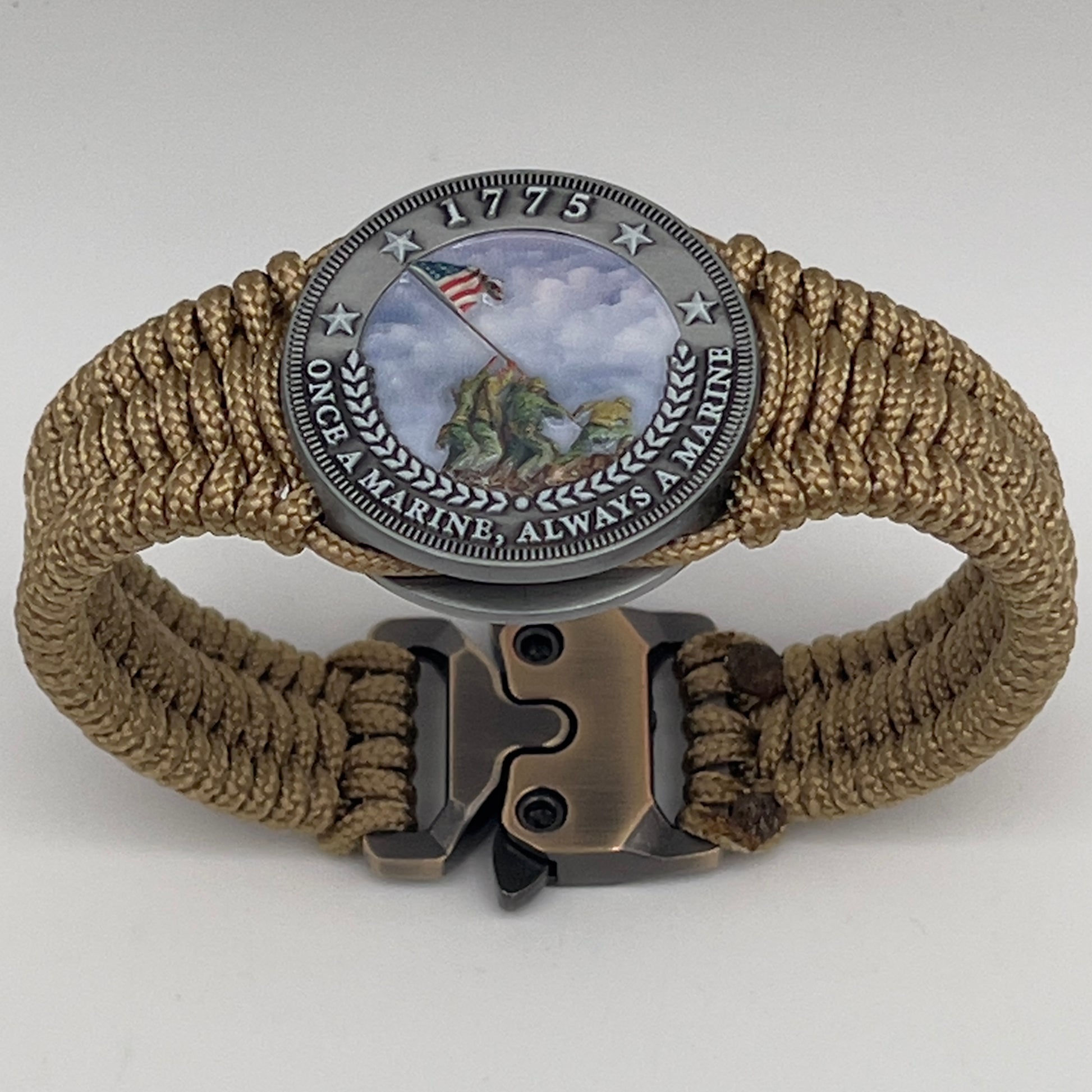Thin, narrow, flexible and comfortable braided United States Marine Corps Iwo Jima bracelet featuring an antique silver plated UV painted Iwo Jima flag raising medallion, a gold Cobra style tactical buckle and woven with gold type-1 paracord.