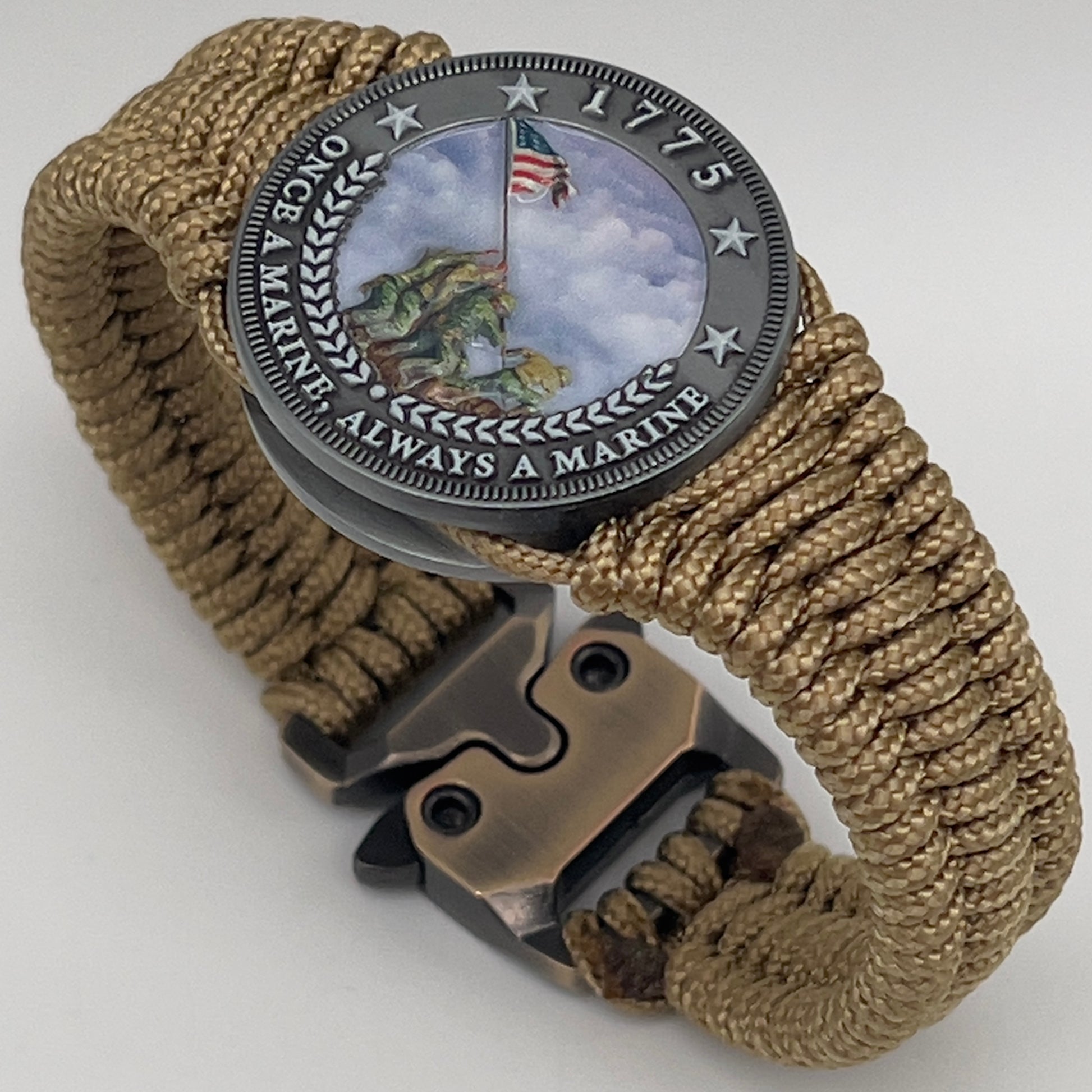 Thin, narrow, flexible and comfortable braided United States Marine Corps Iwo Jima bracelet featuring an antique silver plated UV painted Iwo Jima flag raising medallion, a gold Cobra style tactical buckle and woven with gold type-1 paracord.