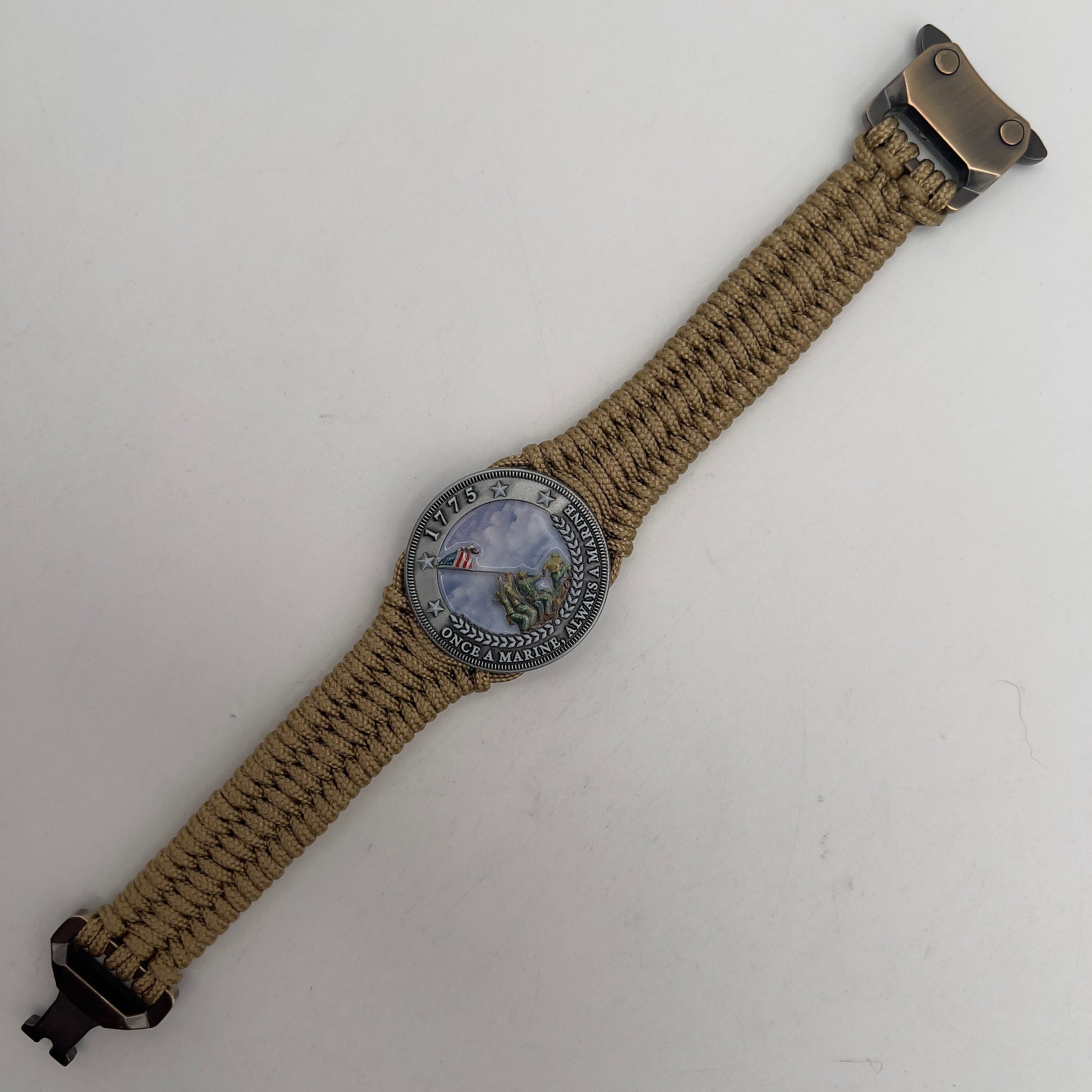 Thin, narrow, flexible and comfortable braided United States Marine Corps Iwo Jima bracelet featuring an antique silver plated UV painted Iwo Jima flag raising medallion, a gold Cobra style tactical buckle and woven with gold type-1 paracord.