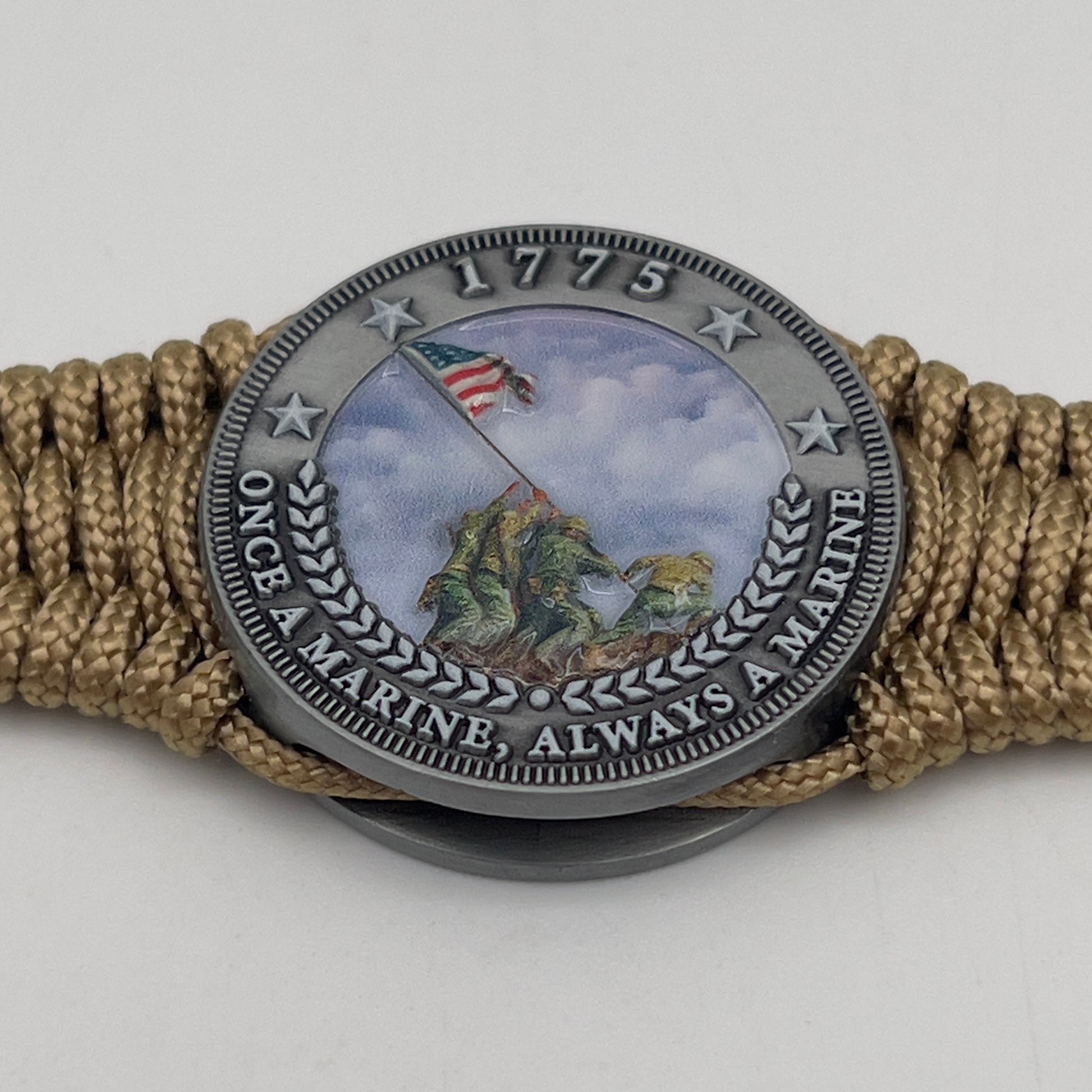 Thin, narrow, flexible and comfortable braided United States Marine Corps Iwo Jima bracelet featuring an antique silver plated UV painted Iwo Jima flag raising medallion, a gold Cobra style tactical buckle and woven with gold type-1 paracord.