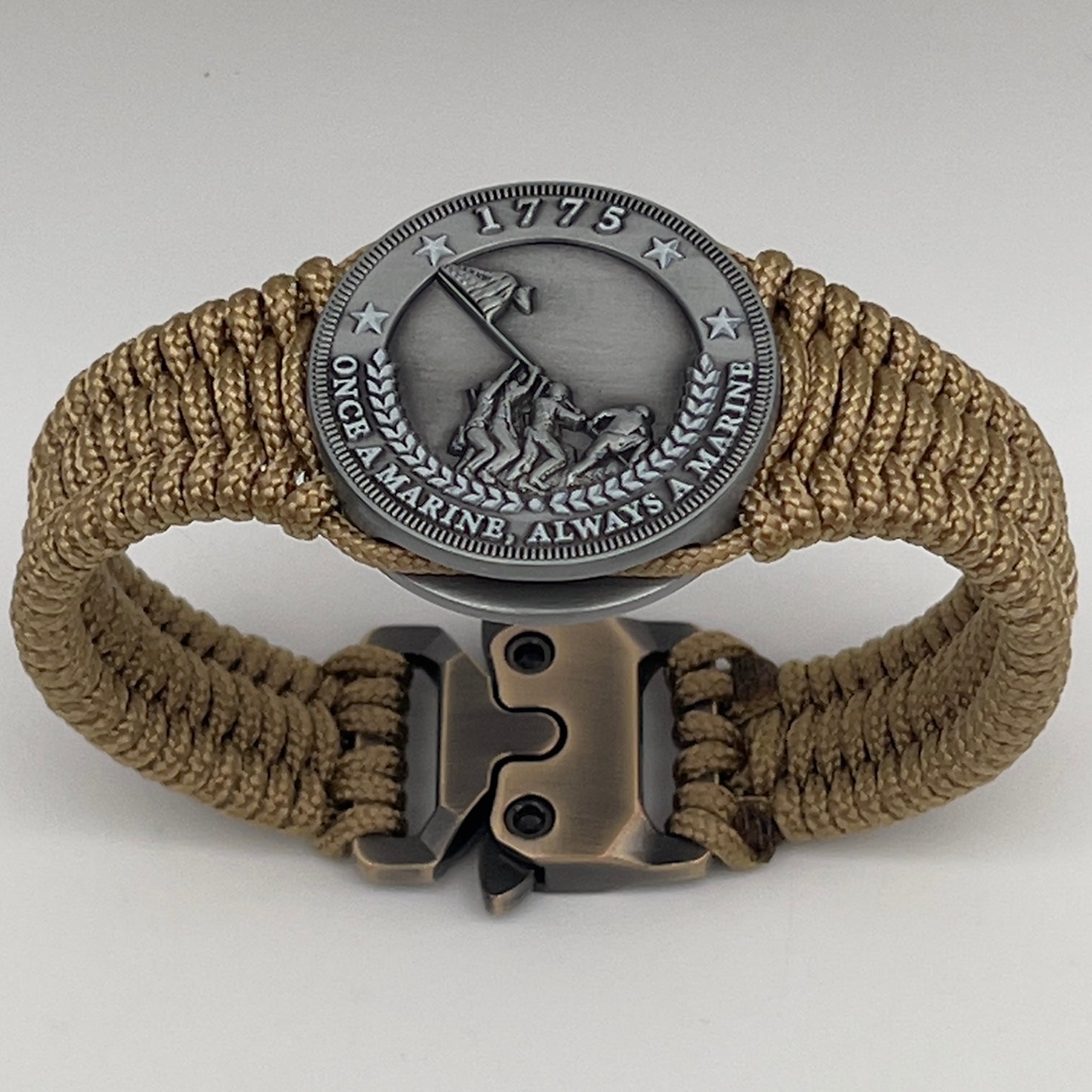 Thin, narrow, flexible and comfortable braided United States Marine Corps Iwo Jima bracelet featuring an antique silver plated Iwo Jima flag raising medallion, a gold Cobra style tactical buckle and woven with gold type-1 paracord.