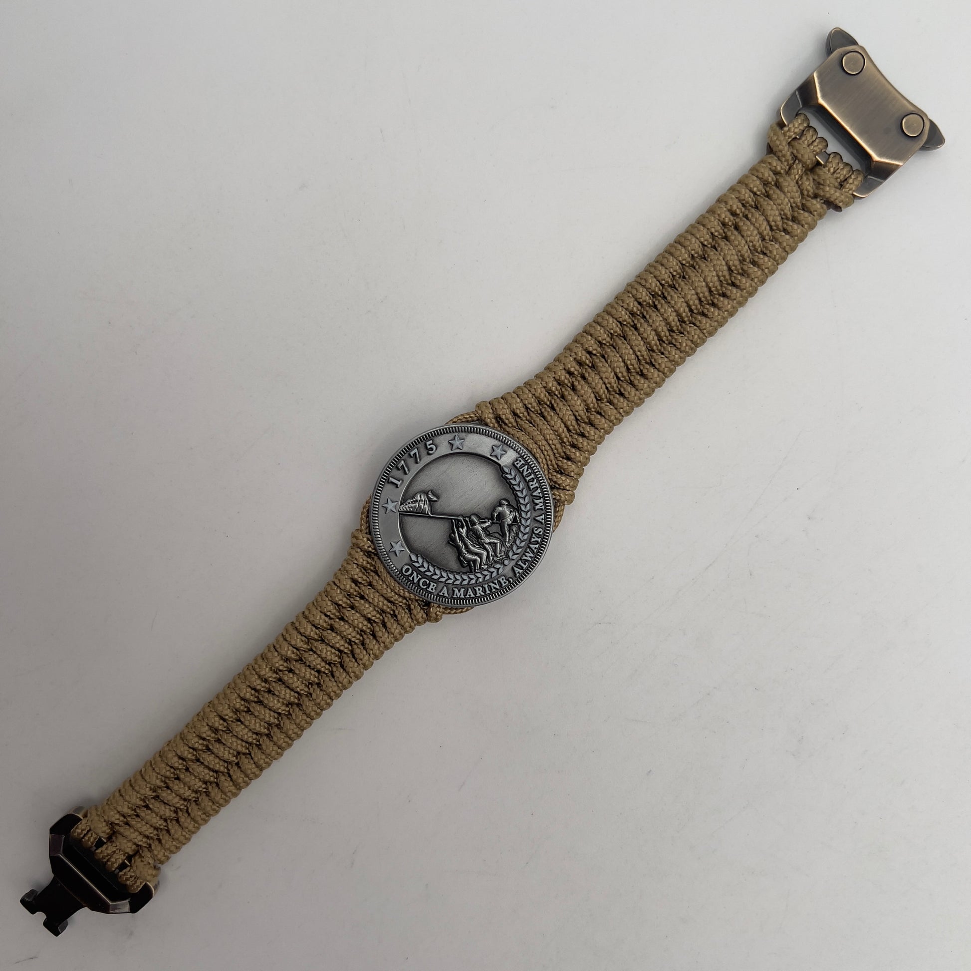 Thin, narrow, flexible and comfortable braided United States Marine Corps Iwo Jima bracelet featuring an antique silver plated Iwo Jima flag raising medallion, a gold Cobra style tactical buckle and woven with gold type-1 paracord.