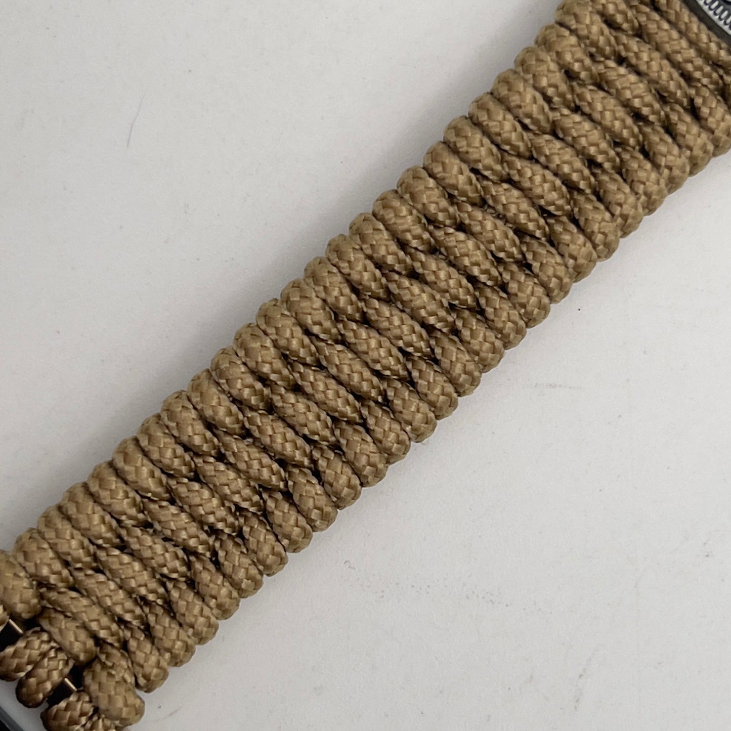 Thin, narrow, flexible and comfortable braided United States Marine Corps Iwo Jima bracelet featuring an antique silver plated Iwo Jima flag raising medallion, a gold Cobra style tactical buckle and woven with gold type-1 paracord.