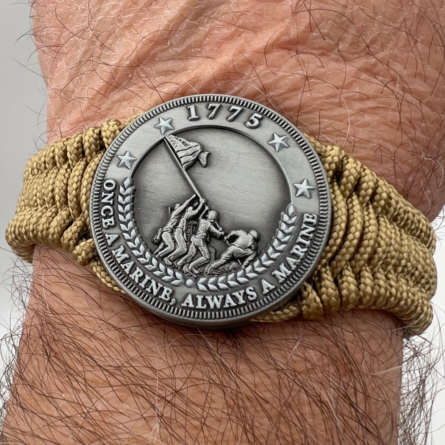 Thin, narrow, flexible and comfortable braided United States Marine Corps Iwo Jima bracelet featuring an antique silver plated Iwo Jima flag raising medallion, a gold Cobra style tactical buckle and woven with gold type-1 paracord.