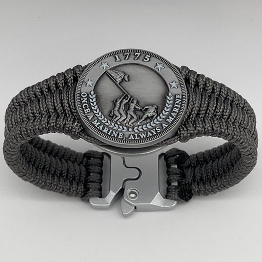 Thin, narrow, flexible and comfortable braided United States Marine Corps Iwo Jima bracelet featuring an antique silver plated Iwo Jima flag raising medallion, a silver Cobra style tactical buckle and woven with Charcoal Gray type-1 paracord.