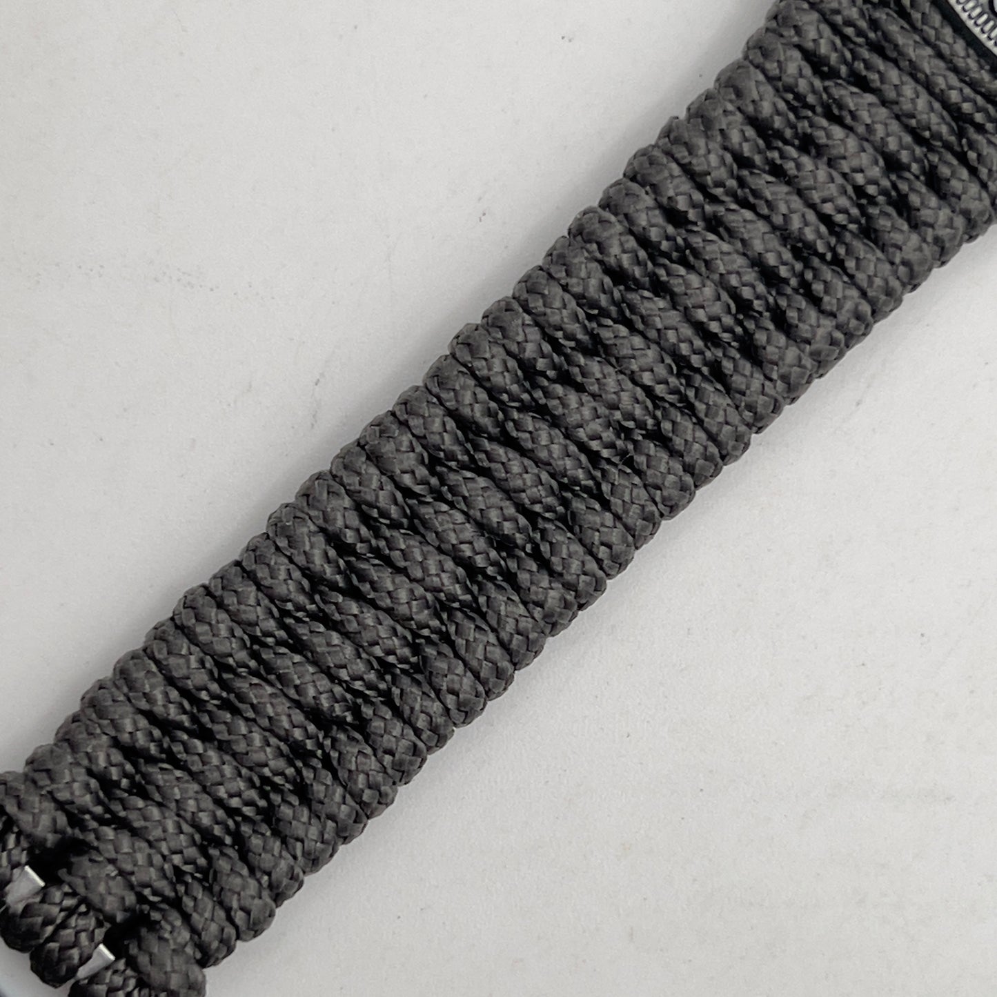 Thin, narrow, flexible and comfortable braided United States Marine Corps Iwo Jima bracelet featuring an antique silver plated Iwo Jima flag raising medallion, a silver Cobra style tactical buckle and woven with Charcoal Gray type-1 paracord.