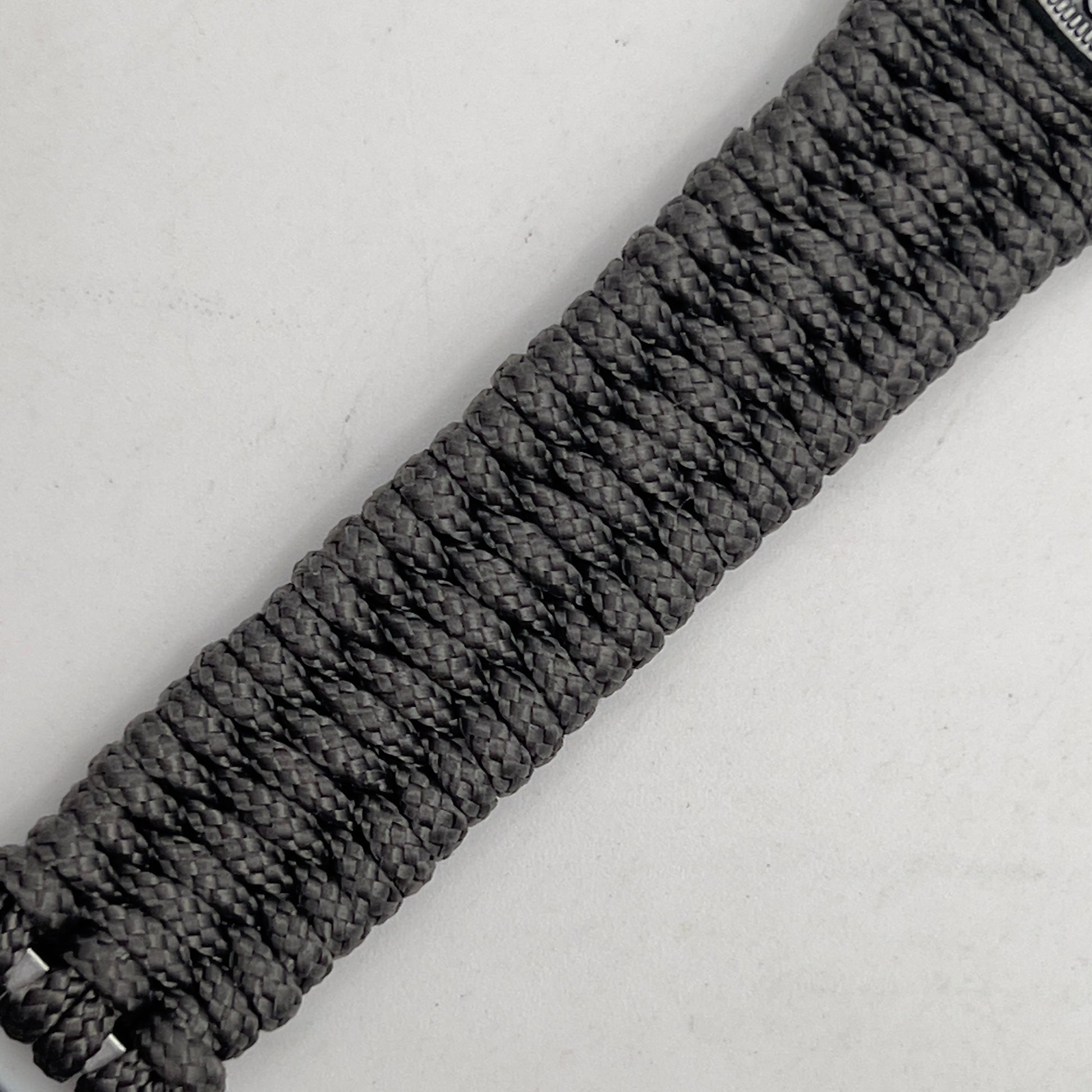 Thin, narrow, flexible and comfortable braided United States Marine Corps Iwo Jima bracelet featuring an antique silver plated Iwo Jima flag raising medallion, a silver Cobra style tactical buckle and woven with Charcoal Gray type-1 paracord.