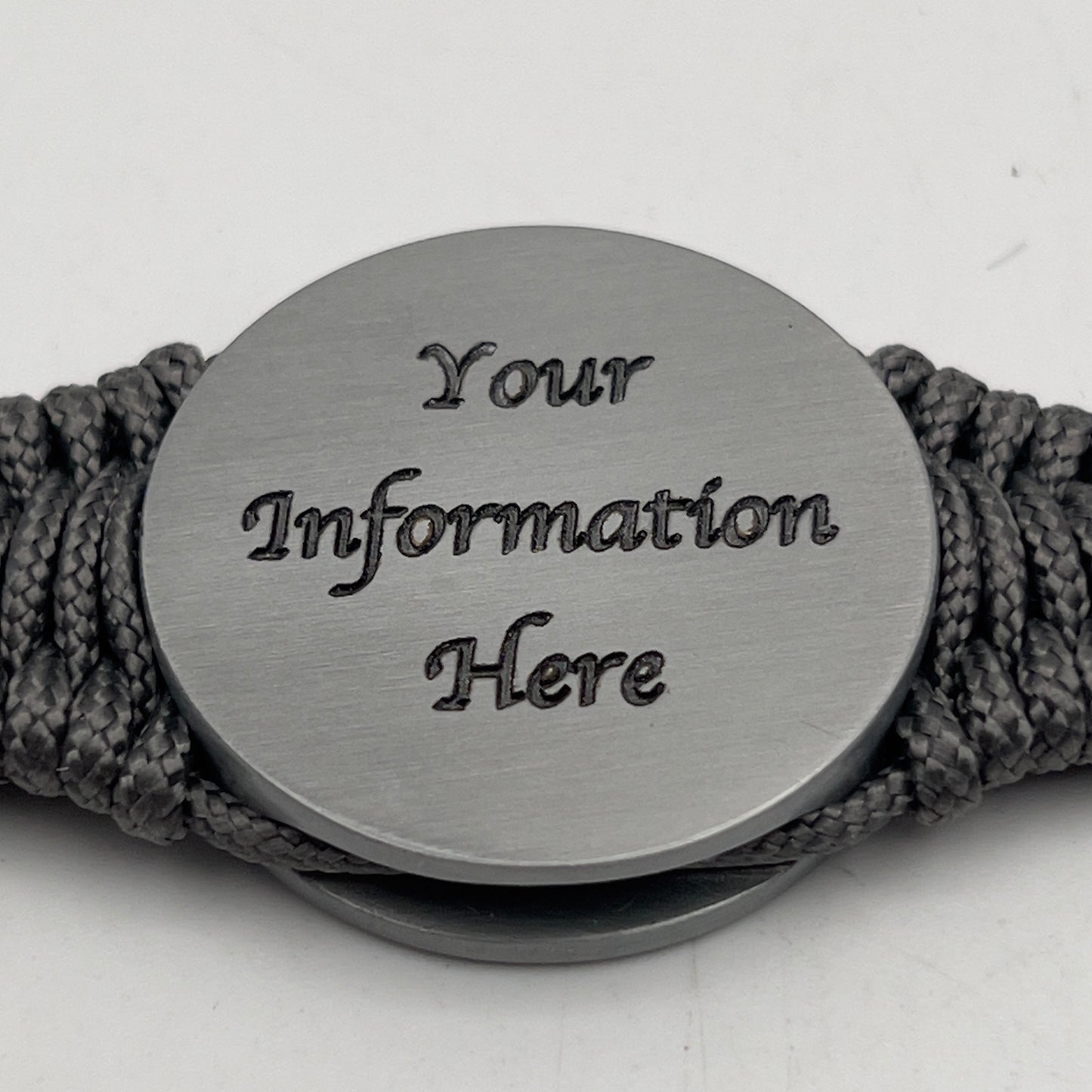 Thin, narrow, flexible and comfortable braided United States Marine Corps Iwo Jima bracelet featuring an antique silver plated Iwo Jima flag raising medallion, a silver Cobra style tactical buckle and woven with Charcoal Gray type-1 paracord.