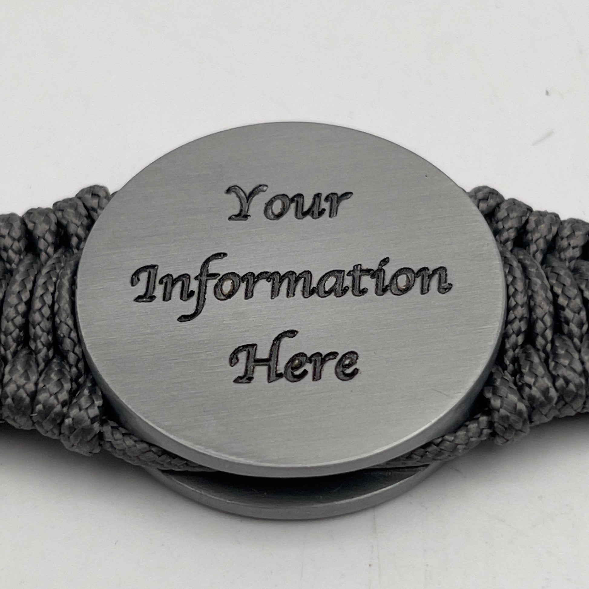 Thin, narrow, flexible and comfortable braided United States Marine Corps Iwo Jima bracelet featuring an antique silver plated Iwo Jima flag raising medallion, a silver Cobra style tactical buckle and woven with Charcoal Gray type-1 paracord.