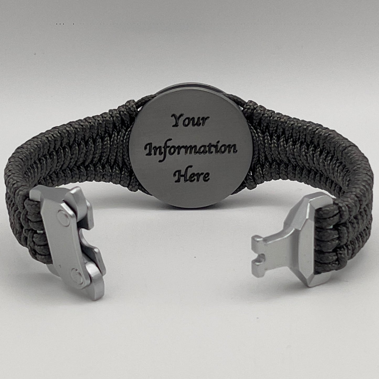 Thin, narrow, flexible and comfortable braided United States Marine Corps Iwo Jima bracelet featuring an antique silver plated Iwo Jima flag raising medallion, a silver Cobra style tactical buckle and woven with Charcoal Gray type-1 paracord.