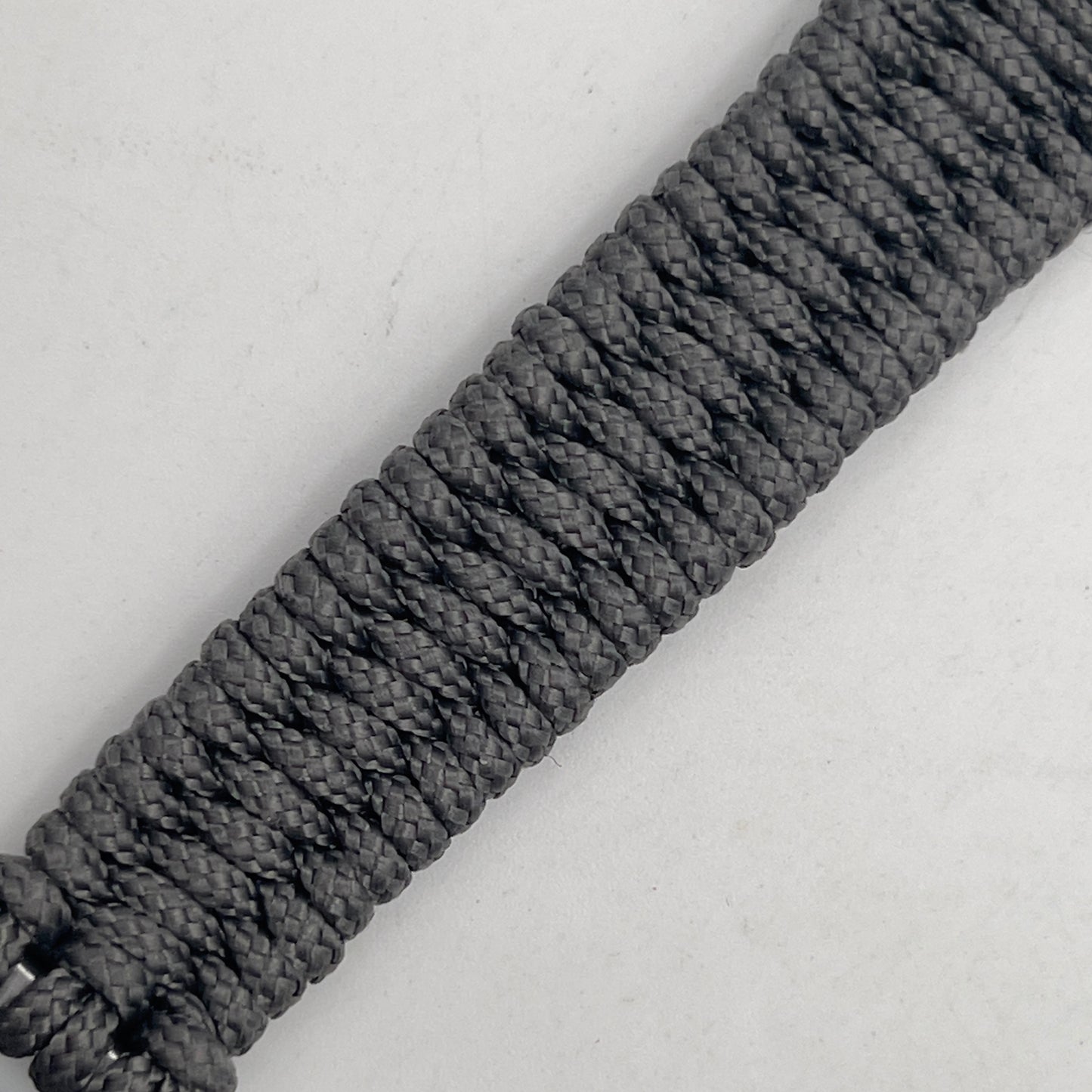 Thin, narrow, flexible and comfortable braided United States Marine Corps Iwo Jima bracelet featuring an antique silver plated UV painted Iwo Jima flag raising medallion, a silver Cobra style tactical buckle and woven with Charcoal Gray type-1 paracord.