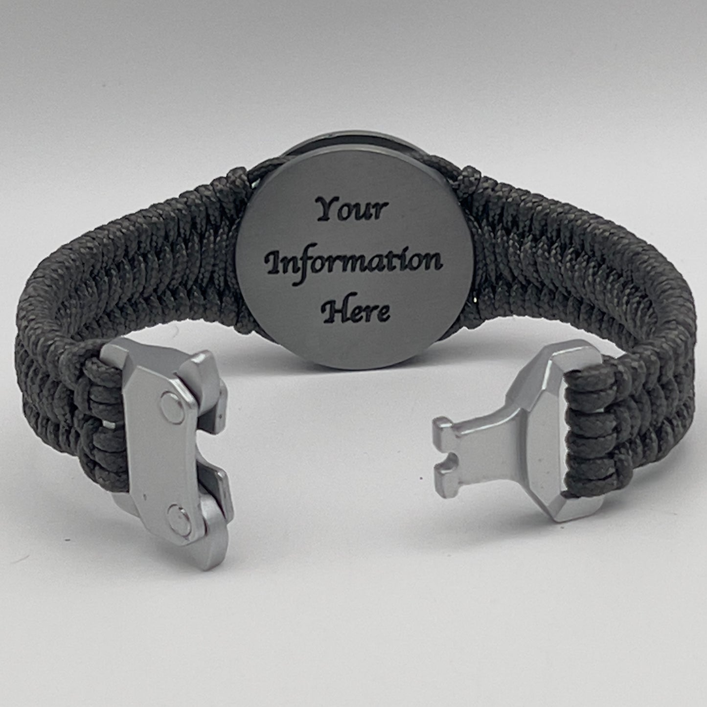 Thin, narrow, flexible and comfortable braided United States Marine Corps Iwo Jima bracelet featuring an antique silver plated UV painted Iwo Jima flag raising medallion, a silver Cobra style tactical buckle and woven with Charcoal Gray type-1 paracord.
