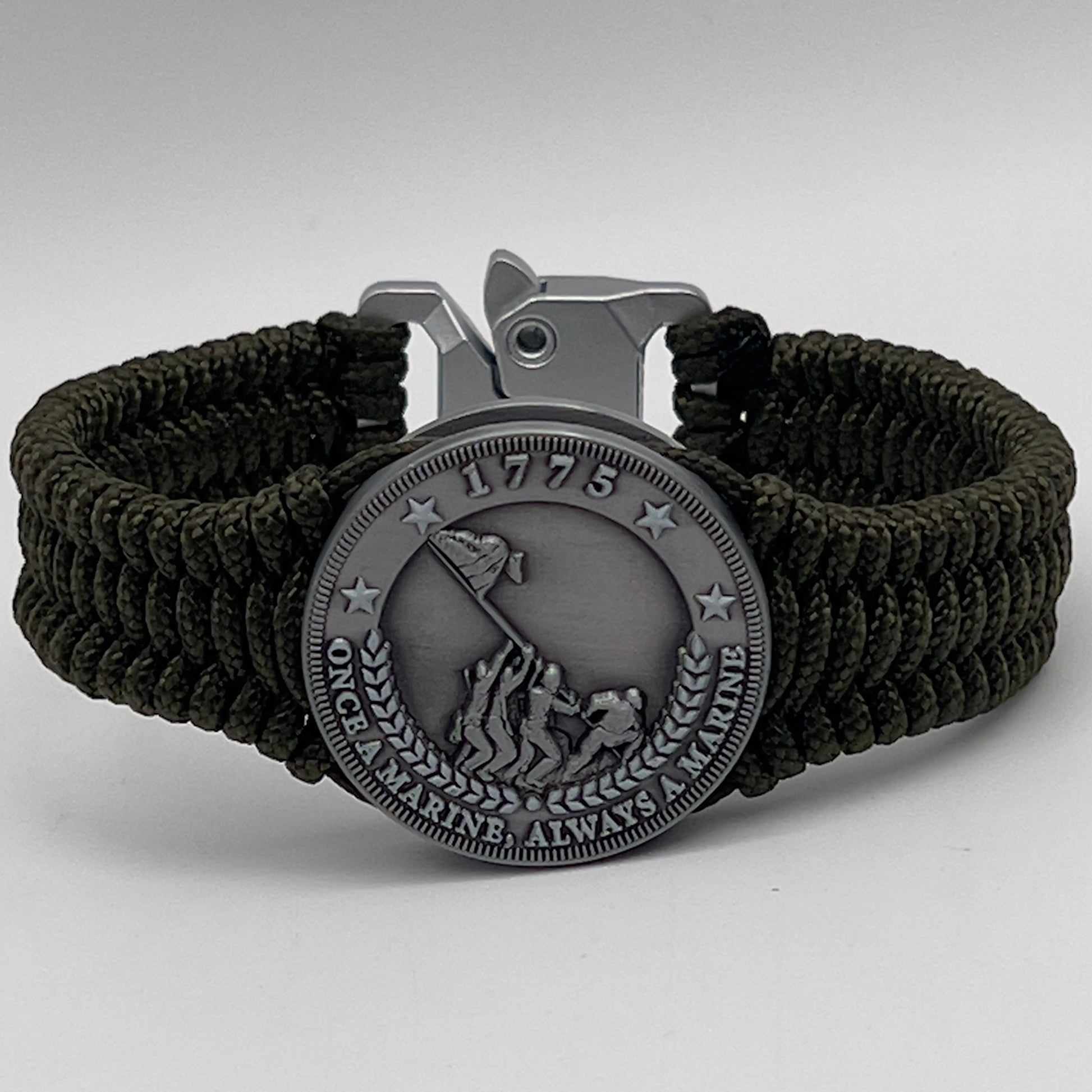 Thin, narrow, flexible and comfortable braided United States Marine Corps Iwo Jima bracelet featuring an antique silver plated UV painted Iwo Jima flag raising medallion, a silver Cobra style tactical buckle and woven with Olive Drab type-1 paracord.