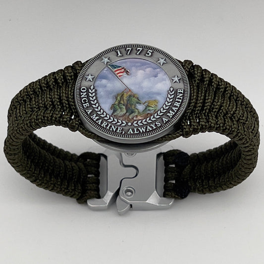 Thin, narrow, flexible and comfortable braided United States Marine Corps Iwo Jima bracelet featuring an antique silver plated UV painted Iwo Jima flag raising medallion, a silver Cobra style tactical buckle and woven with Olive Drab type-1 paracord.