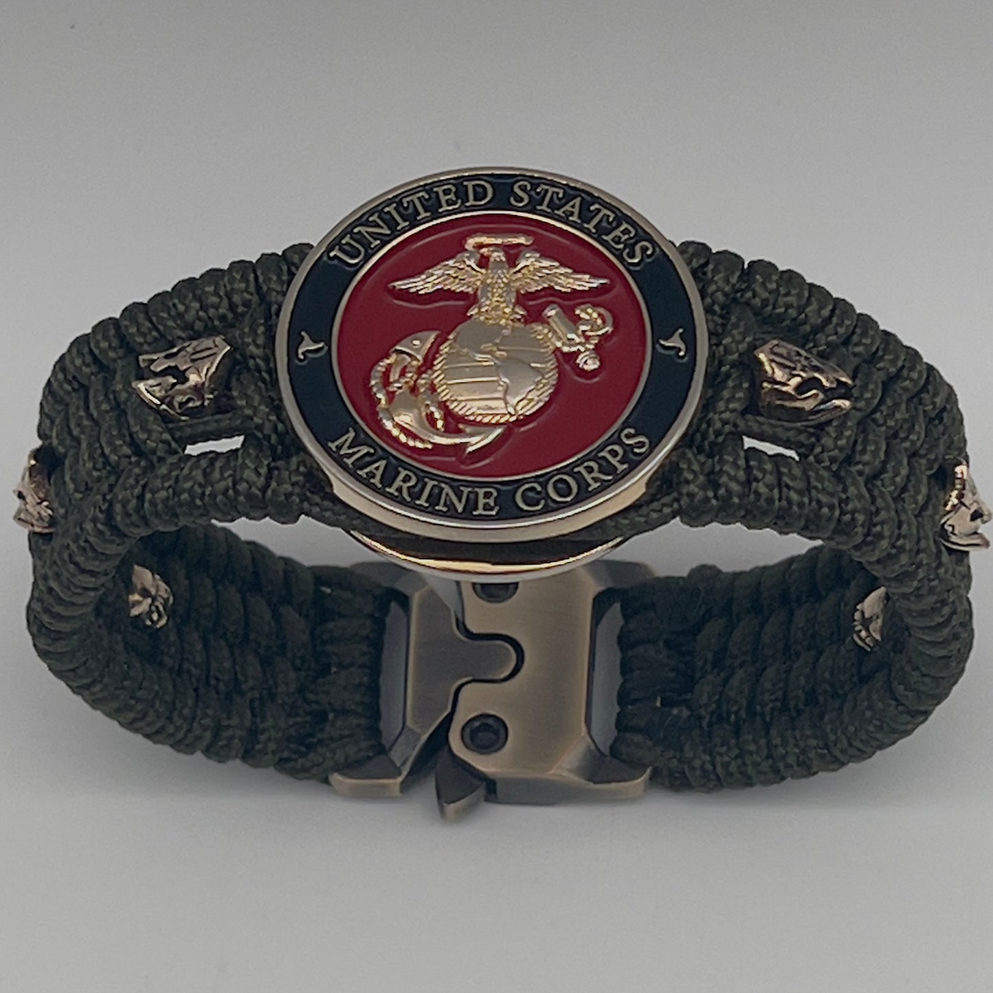 Thin, medium width, flexible and comfortable braided United States Marine Corps bracelet featuring a 24K gold plated USMC officer Eagle Globe and Anchor medallion, six Spartan micro beads, a gold Cobra style tactical buckle and woven with Olive Drab Type-1 paracord.