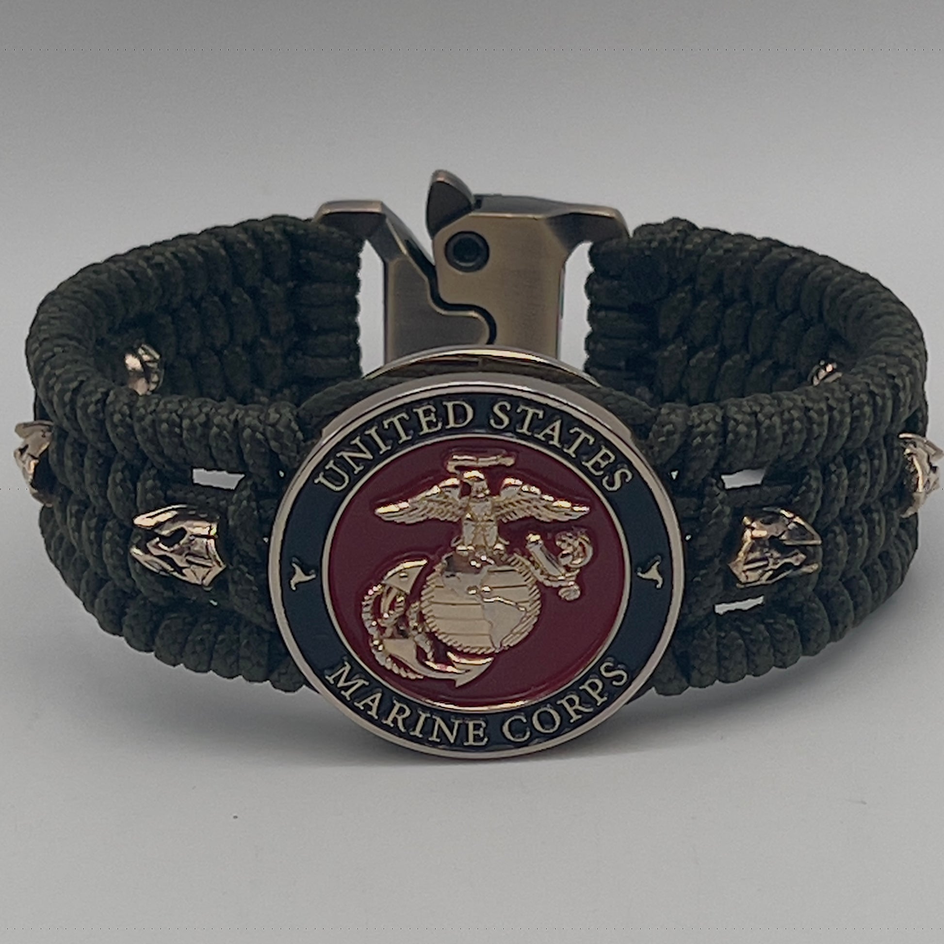 Thin, medium width, flexible and comfortable braided United States Marine Corps bracelet featuring a 24K gold plated USMC officer Eagle Globe and Anchor medallion, six Spartan micro beads, a gold Cobra style tactical buckle and woven with Olive Drab Type-1 paracord.