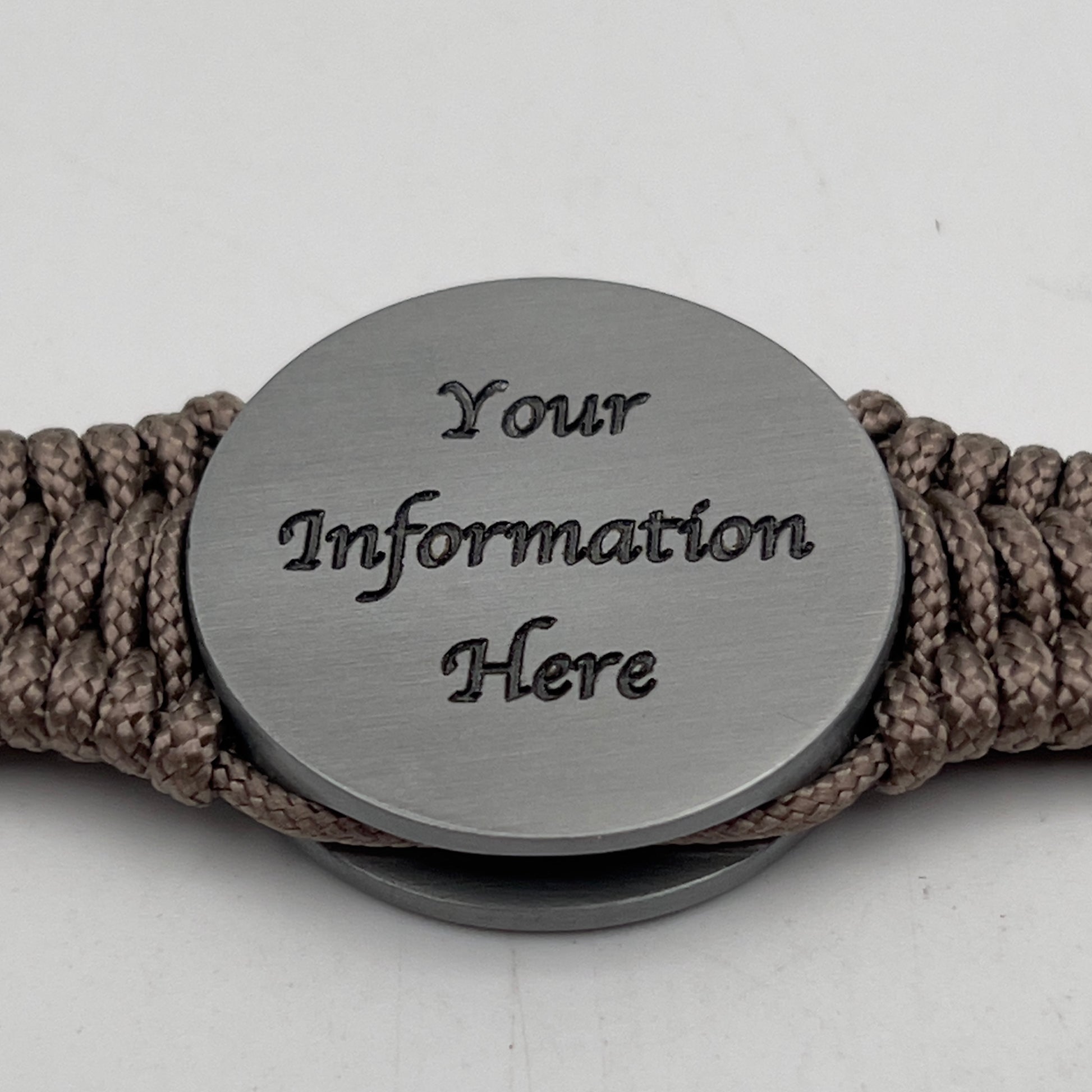 Thin, narrow, flexible and comfortable braided United States Marine Corps Iwo Jima bracelet featuring an antique silver plated Iwo Jima flag raising medallion, a silver Cobra style tactical buckle and woven with tan type-1 paracord.