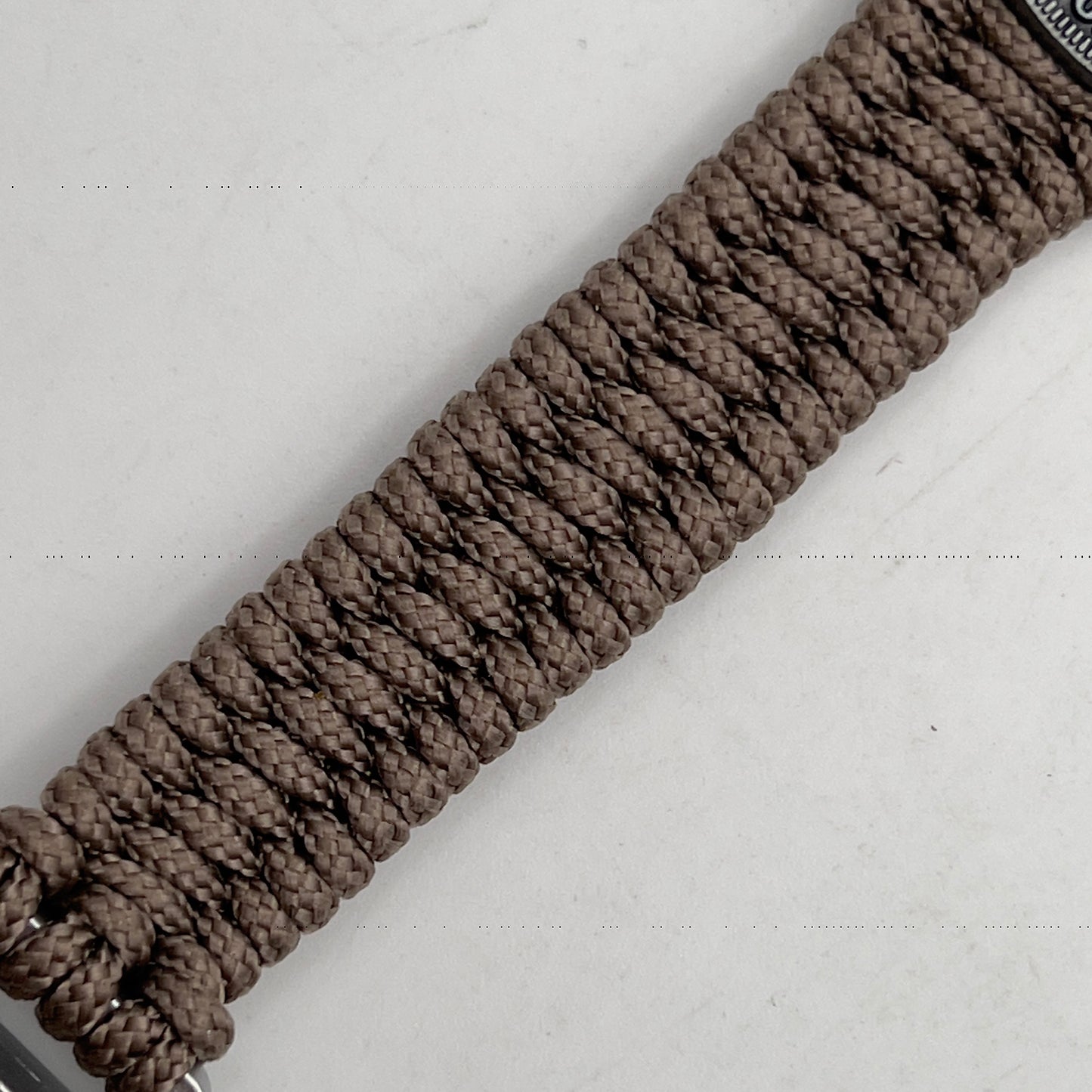 Thin, narrow, flexible and comfortable braided United States Marine Corps Iwo Jima bracelet featuring an antique silver plated UV painted Iwo Jima flag raising medallion, a silver Cobra style tactical buckle and woven with tan type-1 paracord.