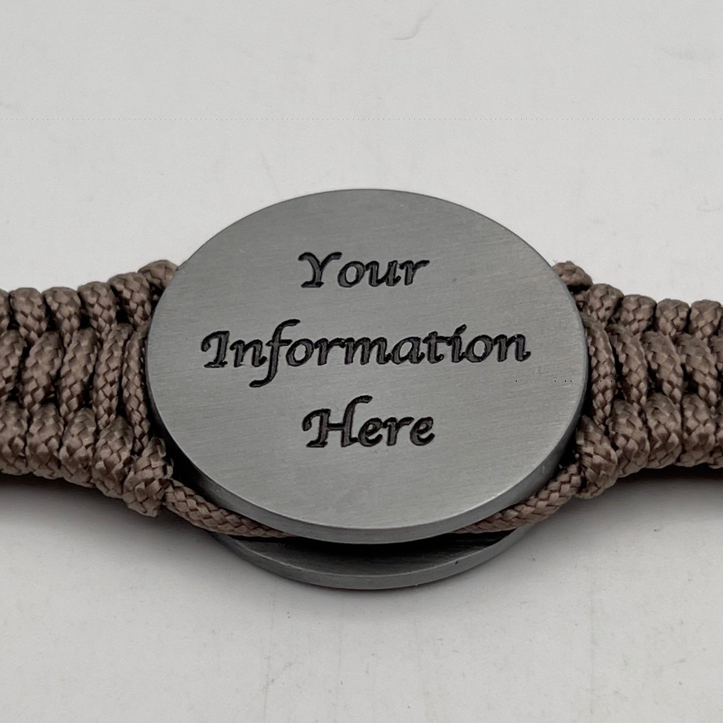 Thin, narrow, flexible and comfortable braided United States Marine Corps Iwo Jima bracelet featuring an antique silver plated UV painted Iwo Jima flag raising medallion, a silver Cobra style tactical buckle and woven with tan type-1 paracord.